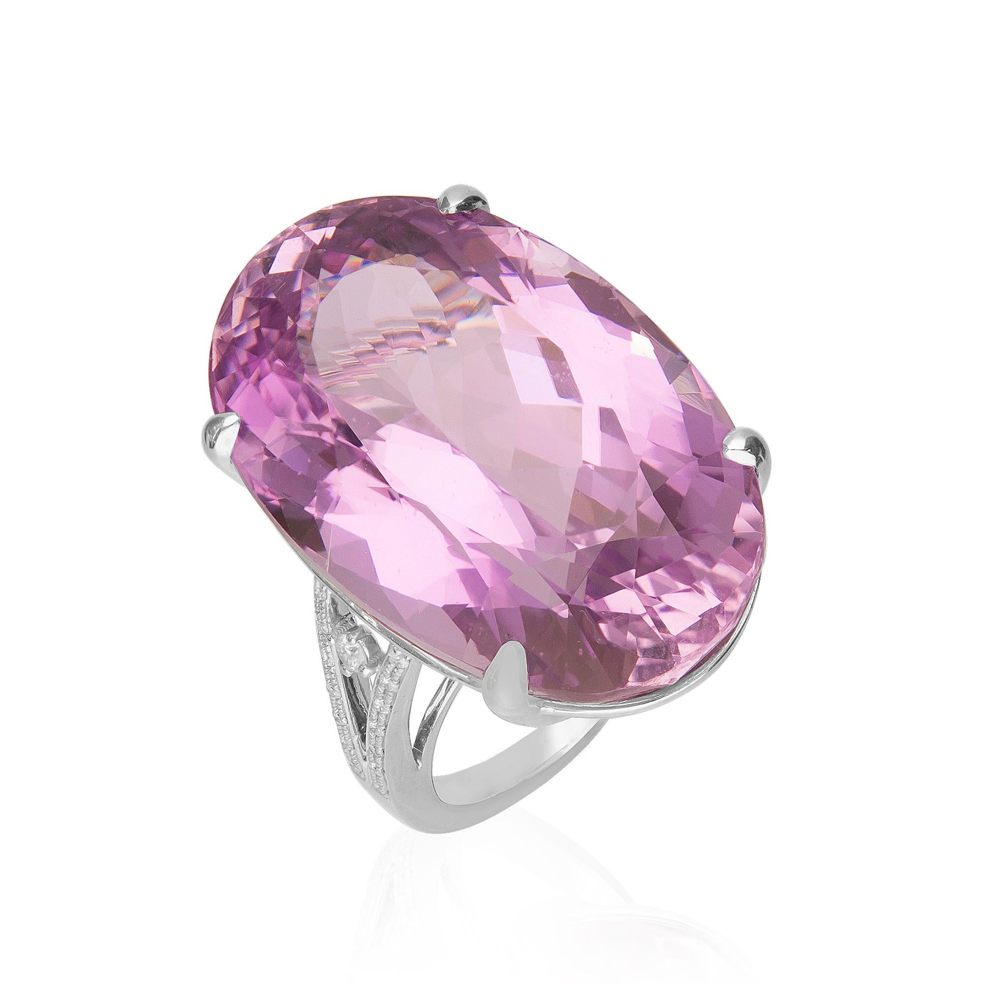 Make a statement with our Cirari Kunzite and diamond ring crafted of 14k white gold. This jewelry is the ideal way to showcase your bold style. This ring features an oval cut kunzite weighing a massive 47 1/8 carats as well as 1/6 carat of