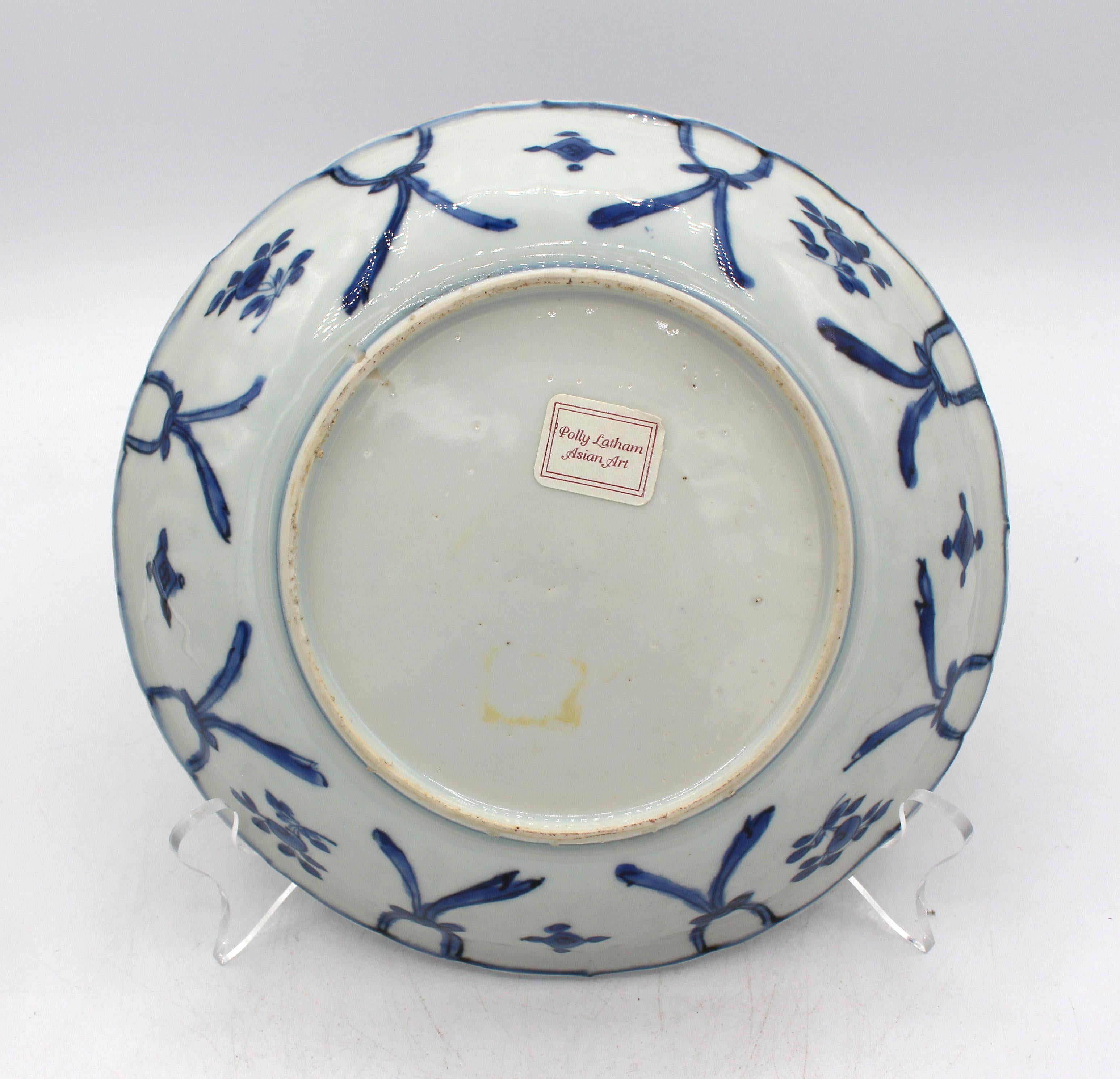 Circa 1573-1619 Wanli, Dynastie Ming, Plat lobé Kraak, exportation chinoise. Porcelaine bleu et blanc. Réserve centrale de 2 faisans parmi les fleurs et les rochers. Bordure de bulbes et de feuilles. Provenance : Label de Pollly Latham Asian Art,