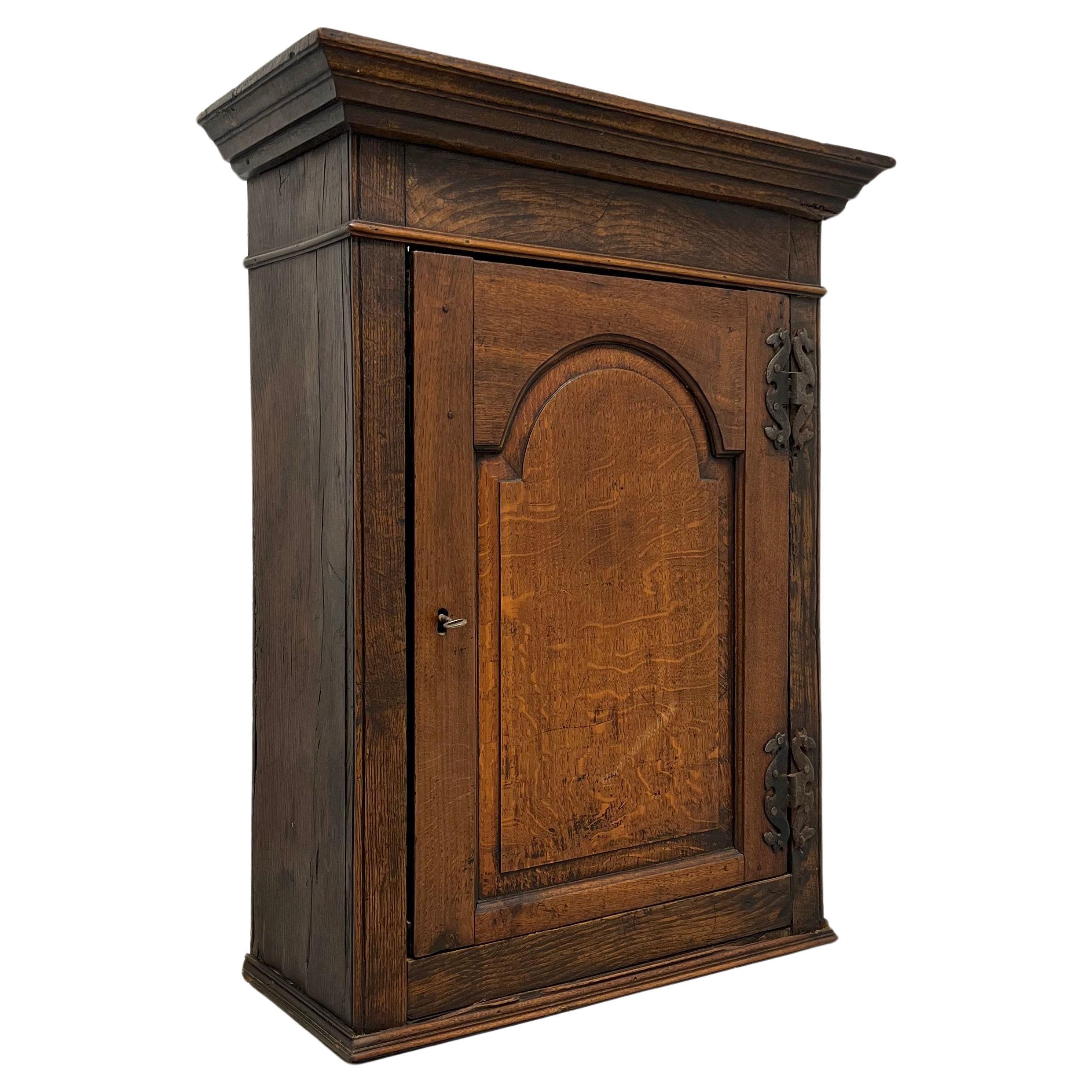 Circa 1700 Quartersawn Oak English Hanging Cupboard with Tombstone Panel Door For Sale