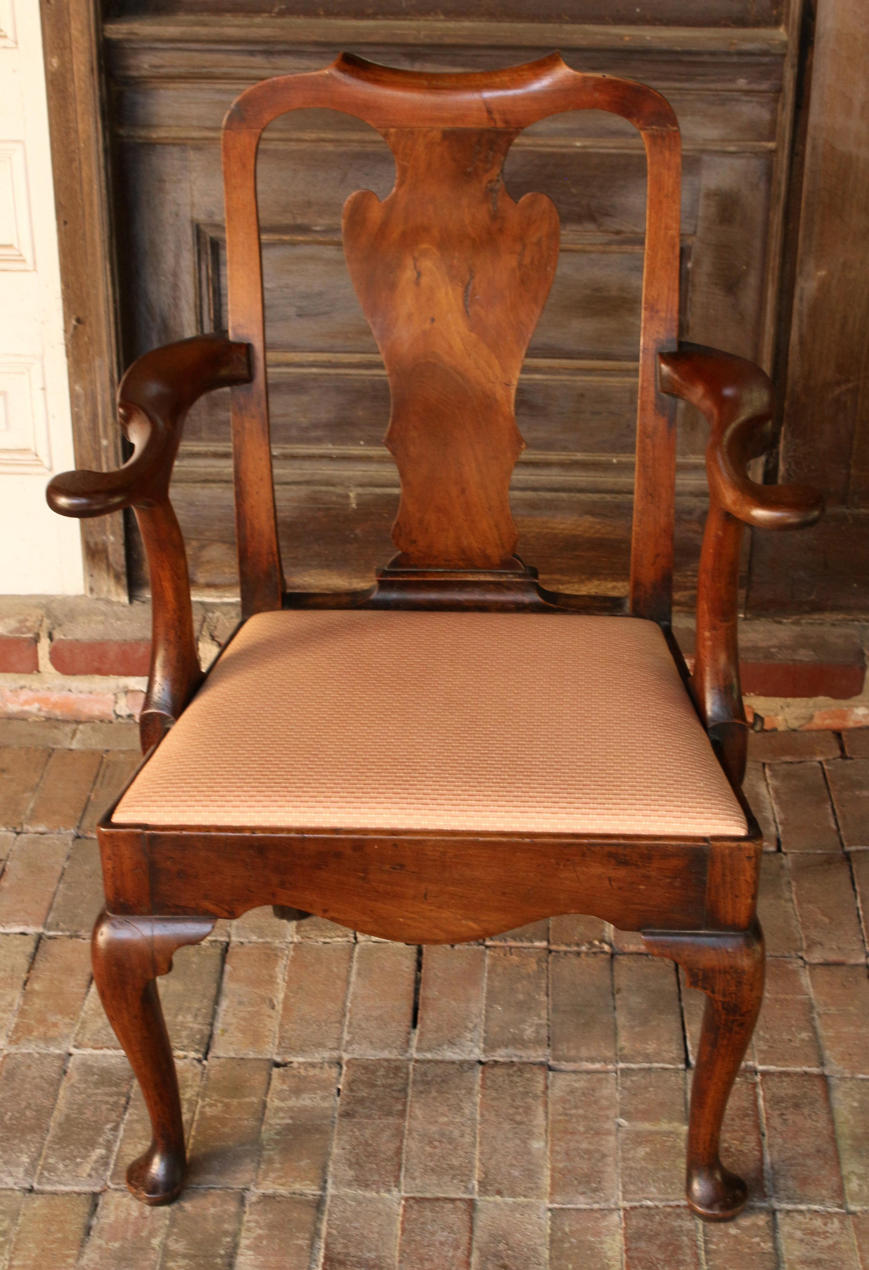George I period walnut armchair, circa 1720-1730. Classically handsome, raised on cabriole legs with pad feet, bold & sculptural arms, well formed aprons. The chair shows good color with a fine old finish. Original seat blocks. Note how well the