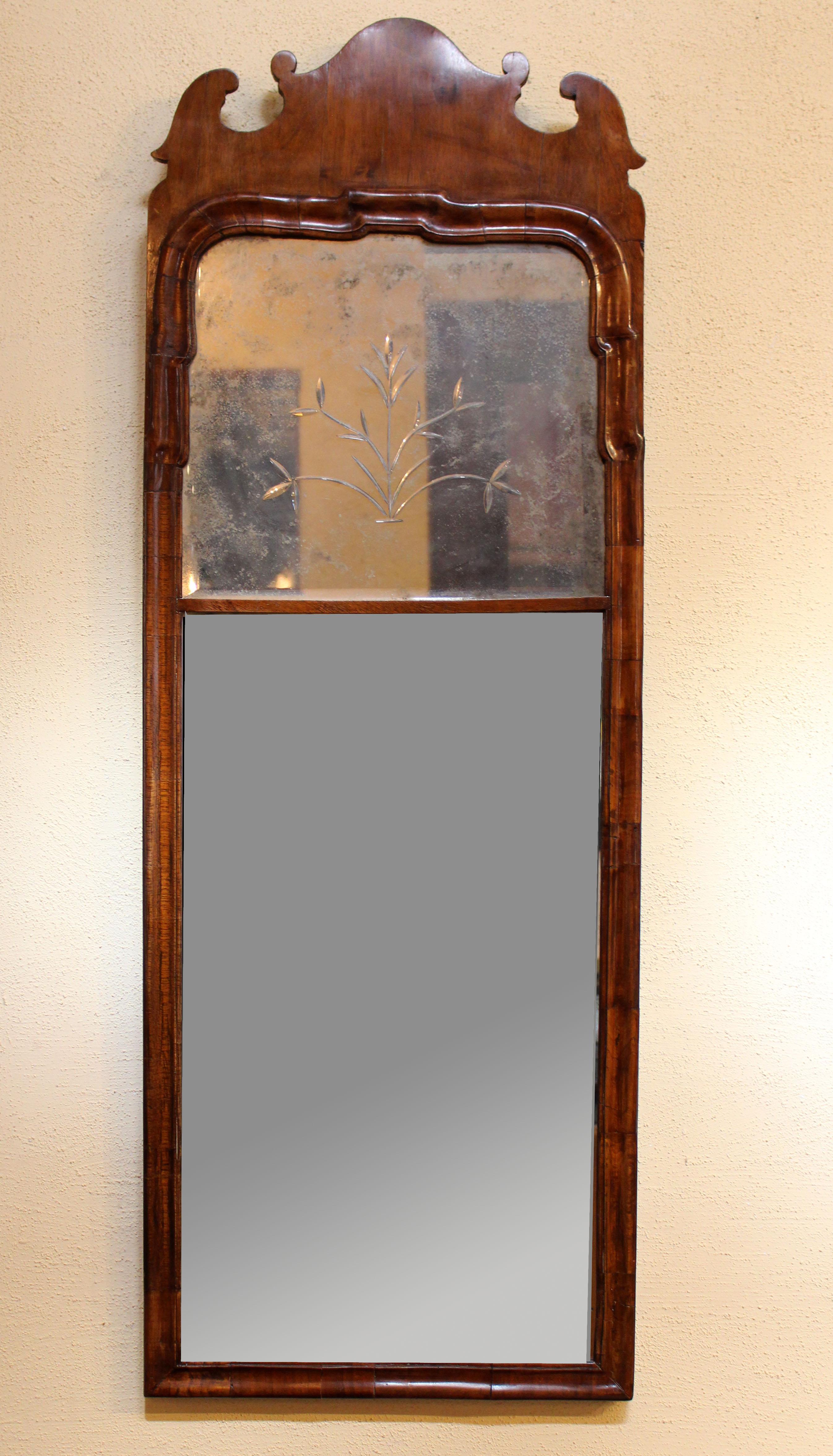 Walnut early George II mirror with original engraved tablet panel and original lower plate, c.1735. Moldings of multiple pieces, as expected for period construction. Pine secondary wood. Provenance: Caroline Faison antiques c.1980. Measures: 45