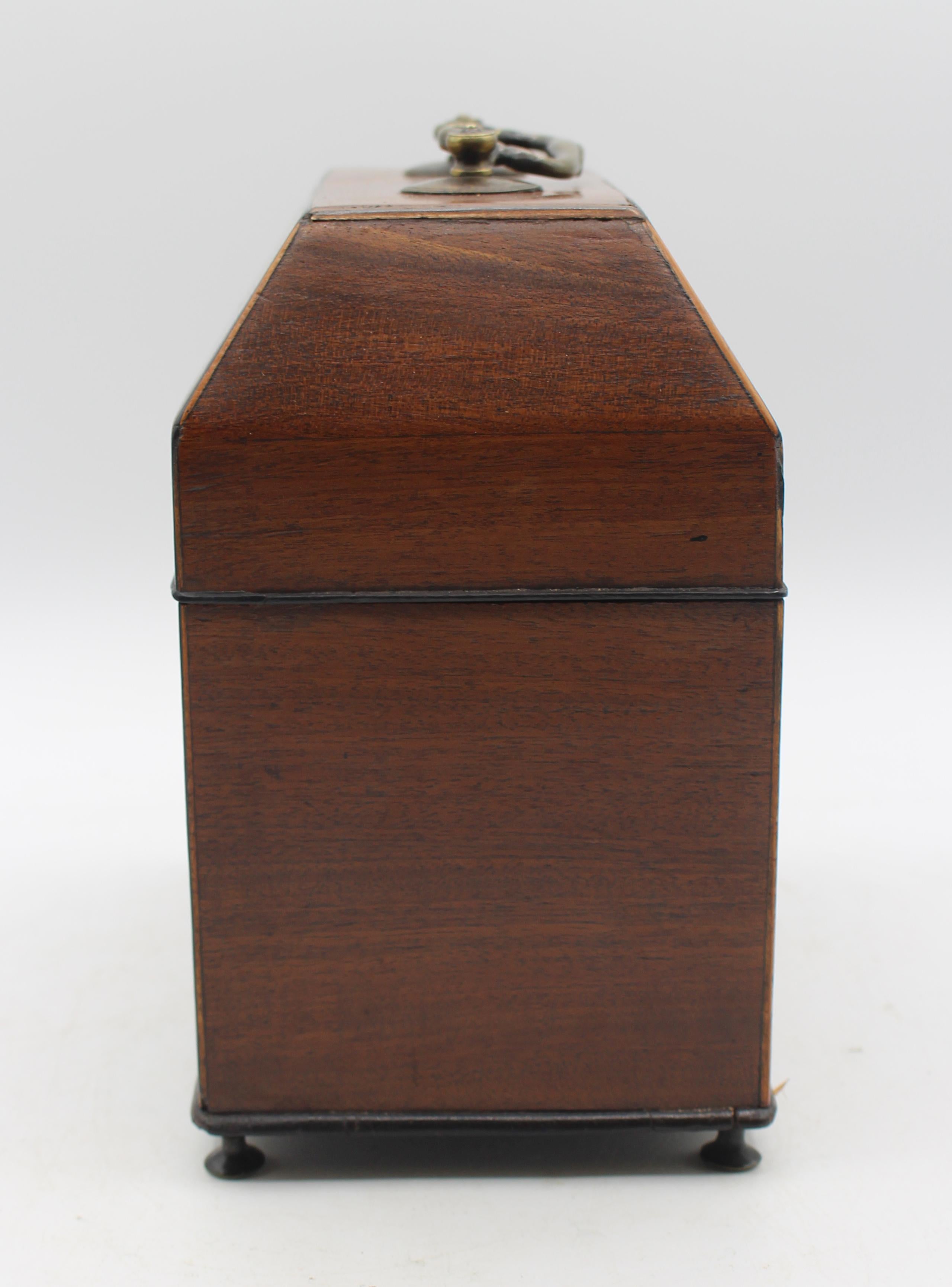 Circa 1750 Georgian high dome-top tea caddy, English. Canted lid to accommodate tall glass or porcelain caddies (now replaced by Victorian era purple velvet). An unusual form related to early knife boxes. Boxwood. Raised on flat spool brass feet.