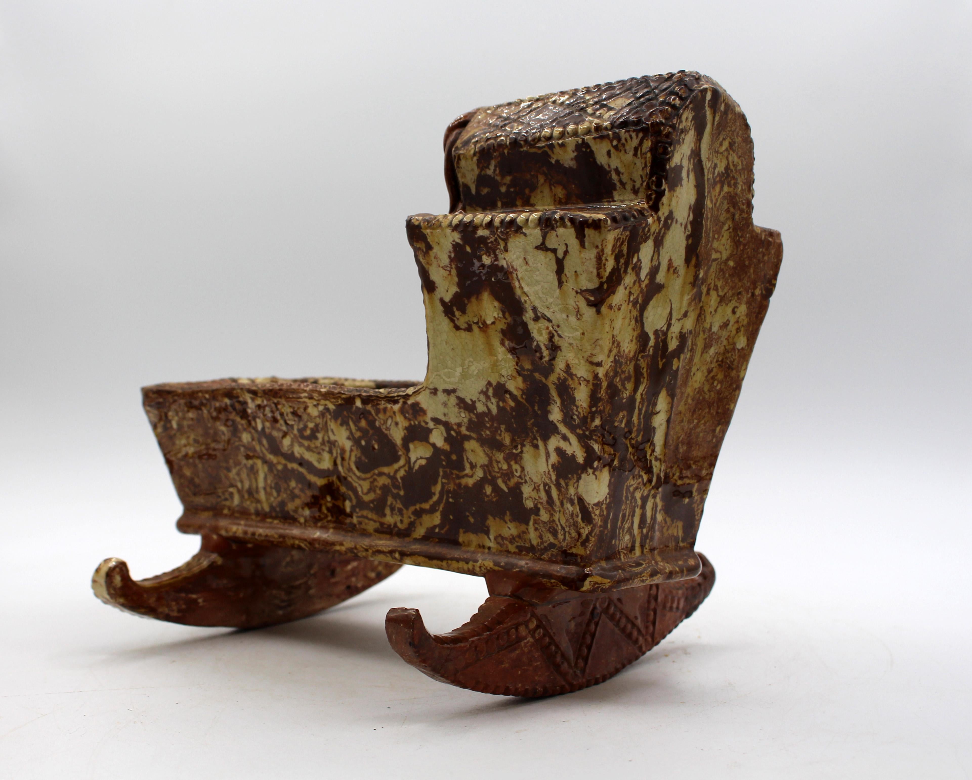 Circa 1750 agateware or scroddleware pottery miniature cradle, English. Likely Staffordshire. Marbled creams & brown/reddish brown clays. Comingled solid clays unglazed on rockers indicative of this rare form. Two rocker tips are re-stuck. Favored
