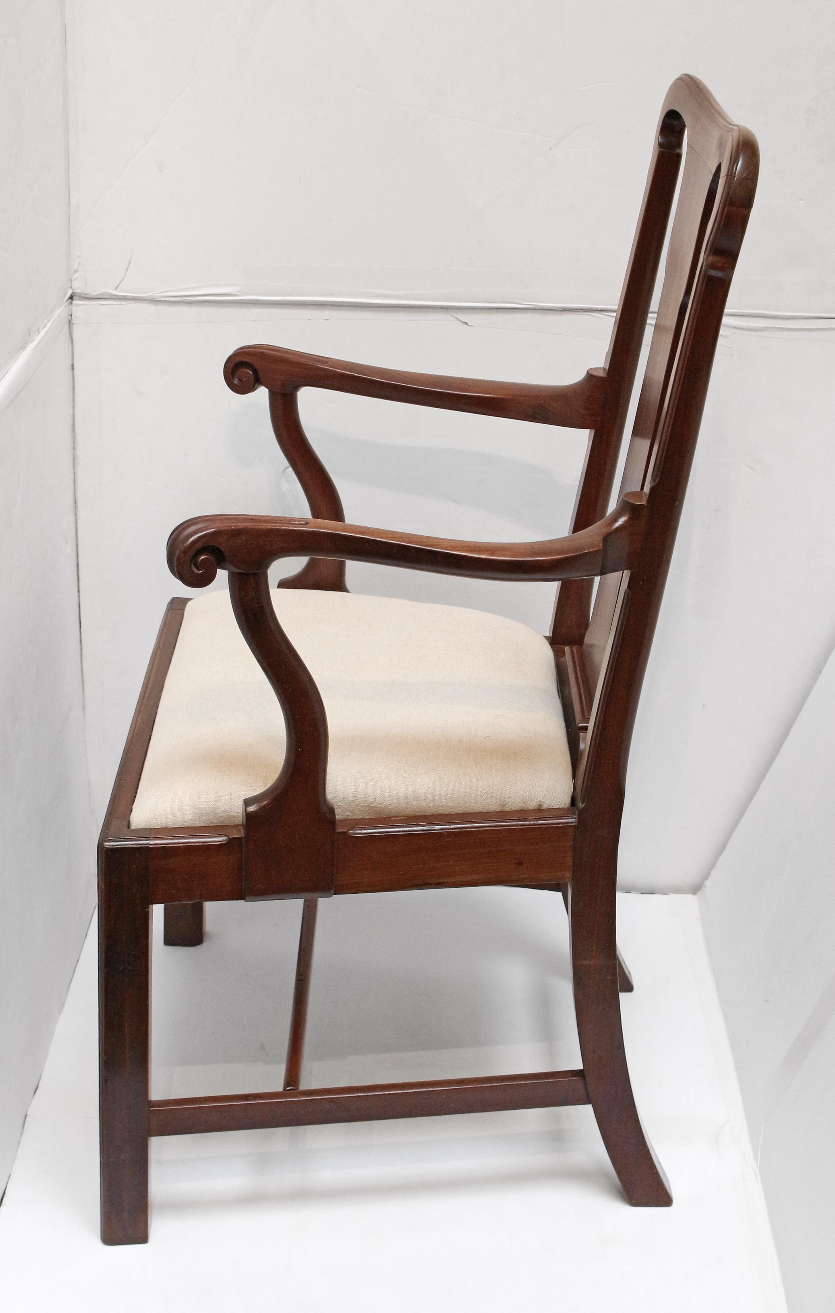 George II circa 1750 Irish arm chair. Mahogany. Slip seat. Raised on square legs with rear & I-stretchers. Gracefully shaped arms ending in boldly formed knuckles to curved uprights. The back clearly in transitional Queen Anne to Georgian taste.