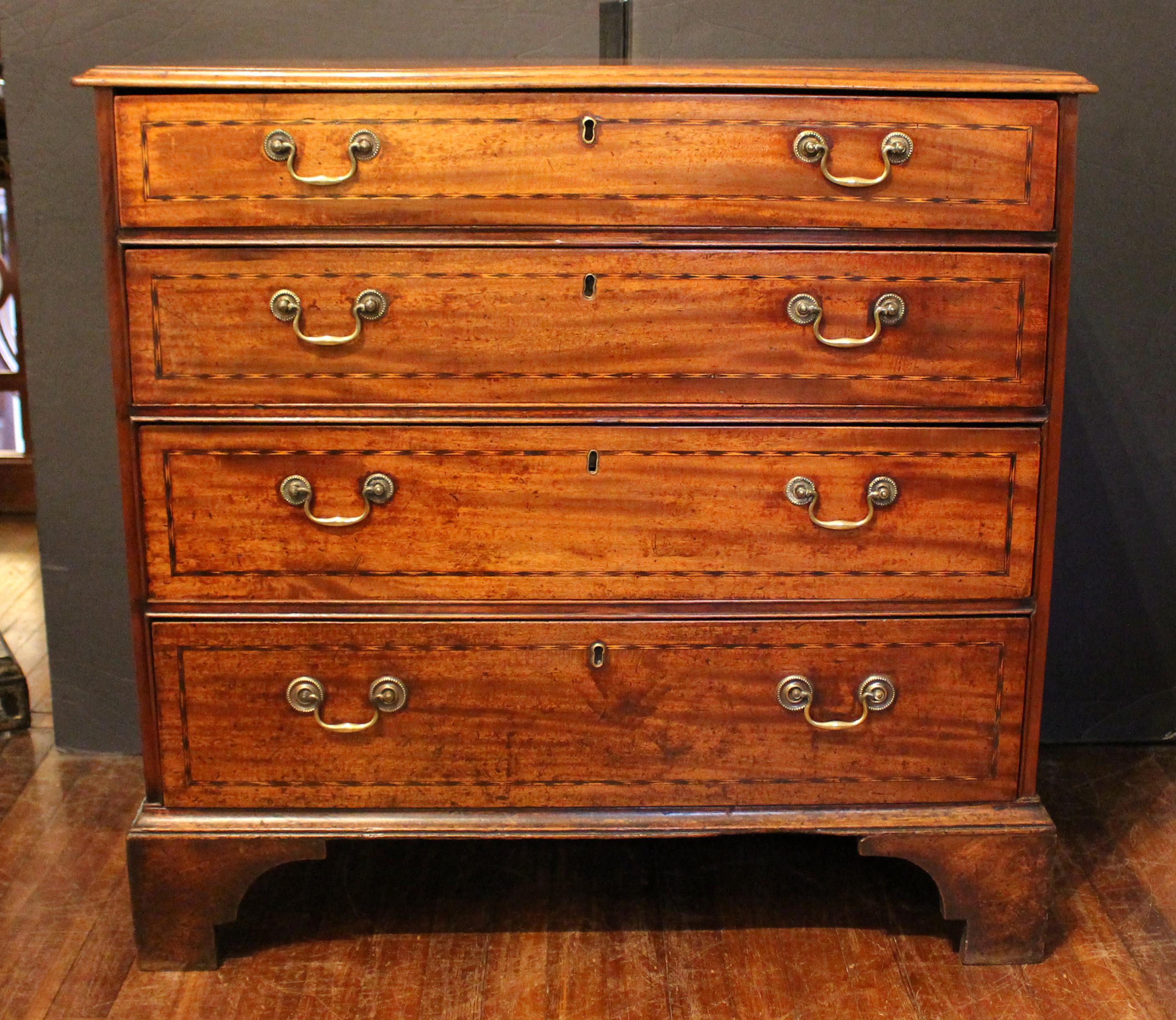 Circa 1760-70 George III chest of drawers, English. 4 graduated drawers form. Mahogany. Solid mahogany drawer fronts with oak & deal secondary woods. Checkered line inlaid drawer fronts. Thumb molded top. Well shaped bracket feet. Original bail &