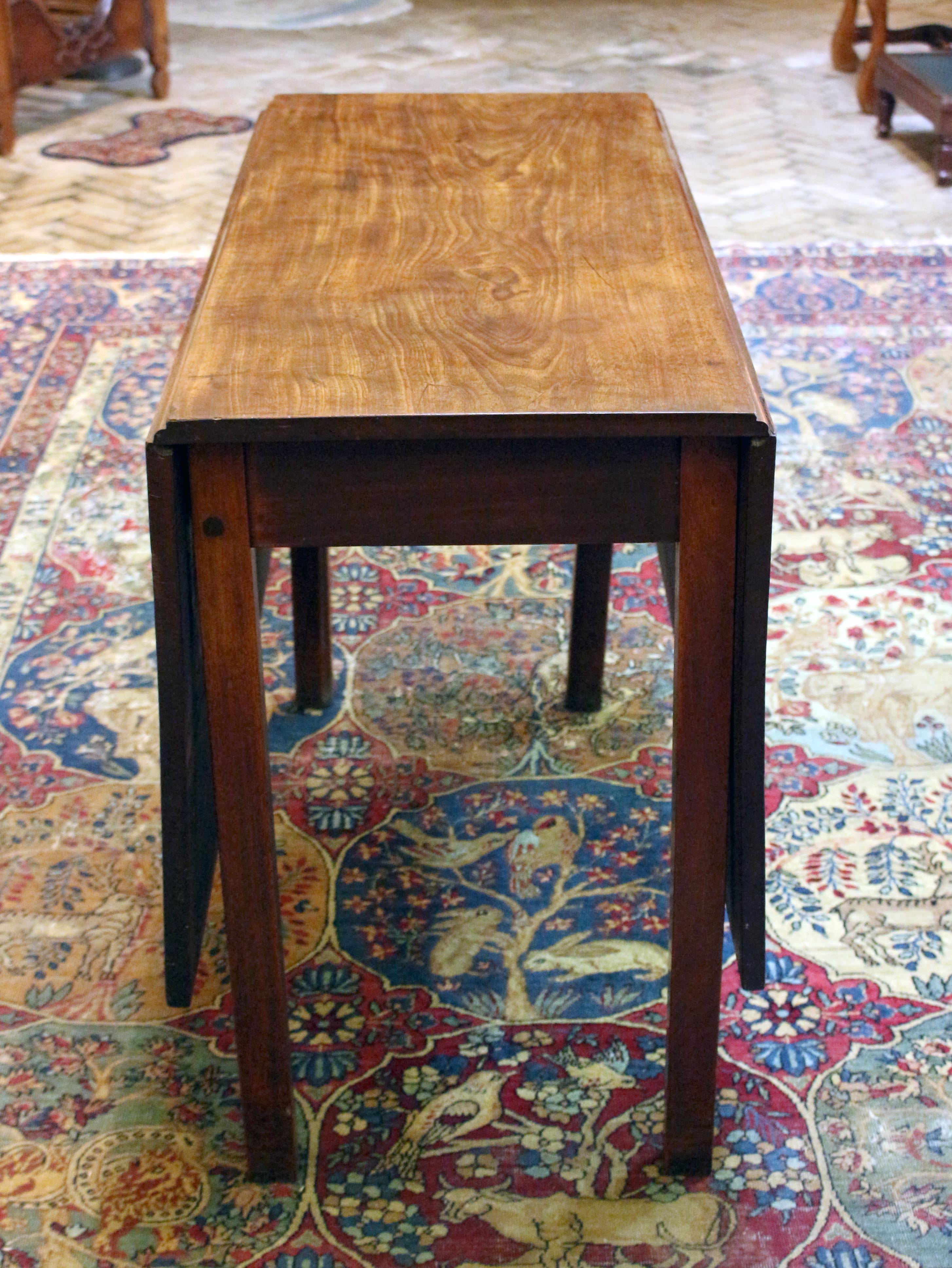circa 1760 Georgian drop leaf table, English. Heavy, quality early mahogany. Straight, square legs. Slight warping visible toward the edge of the top. Old leg joint repair. 38.5