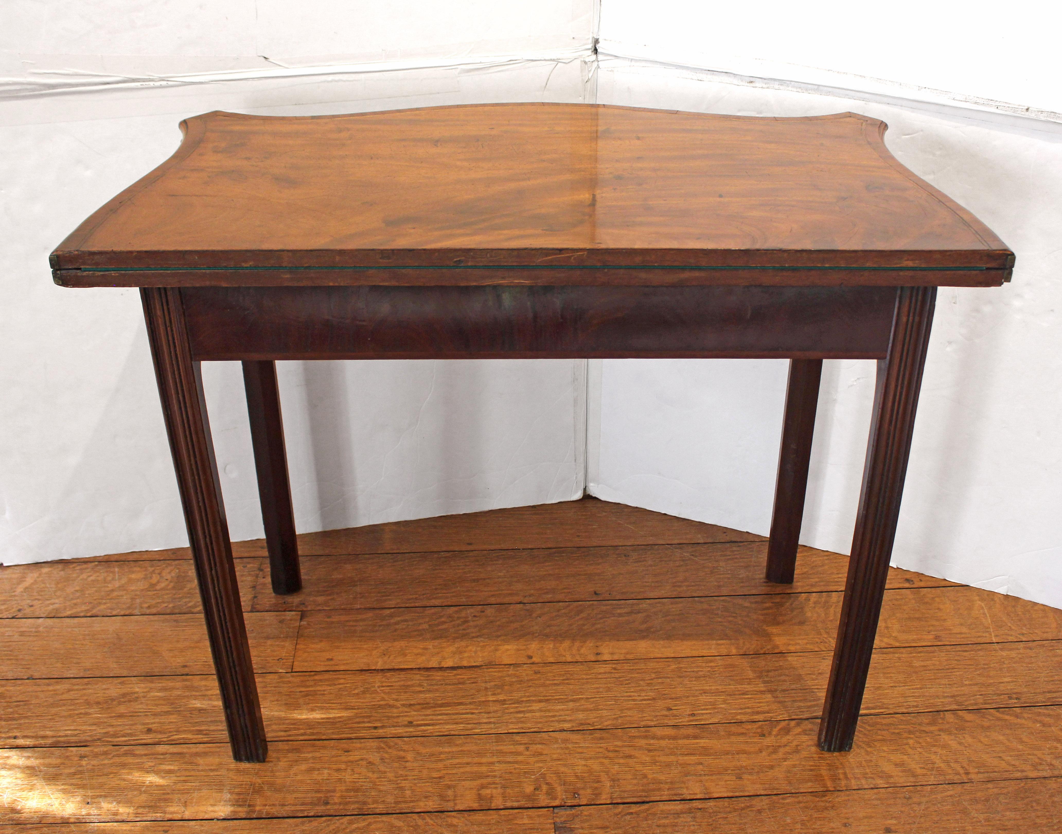 Circa 1765 George III period games table, English. Desirable concertina action support legs & apron when the table is open for gaming; baize gaming surface. Superb quality Chippendale taste. Raised on square, molded legs. Well figured mahogany with