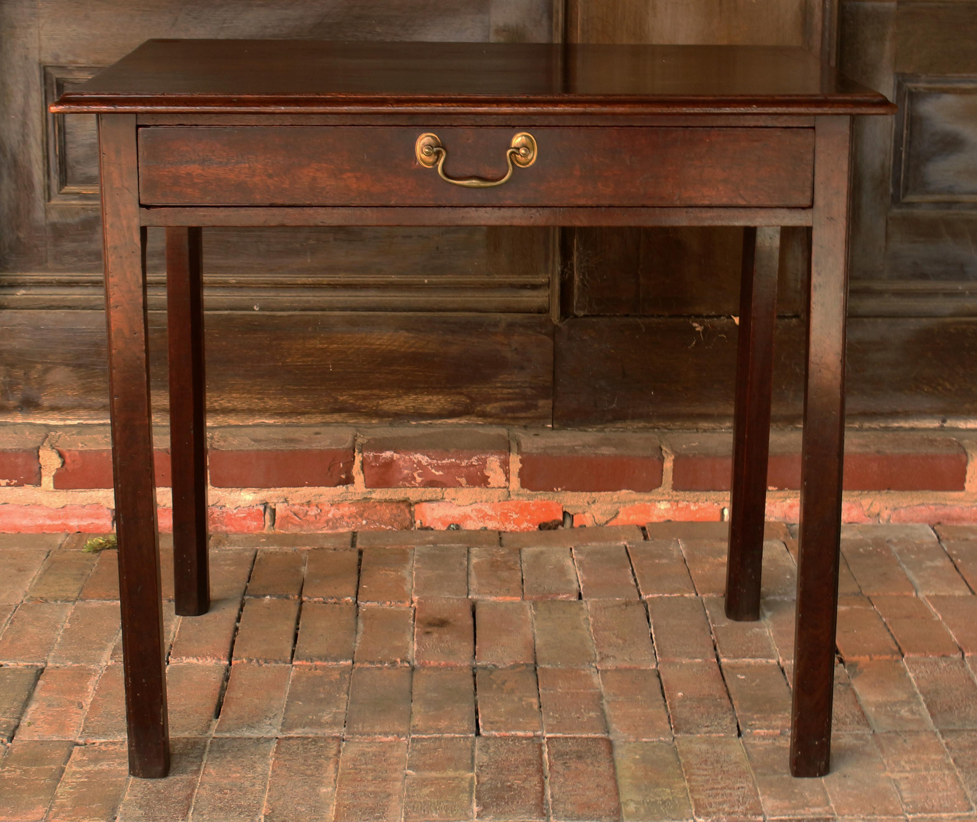 Mesa auxiliar Jorge III. Caoba de Santa Domingo de rico color, hacia 1765. Un solo cajón largo con tirador original. De líneas clásicas, con la parte superior moldeada y elevada sobre patas angulares cuadradas de caña simple moldeada. Roble Madera