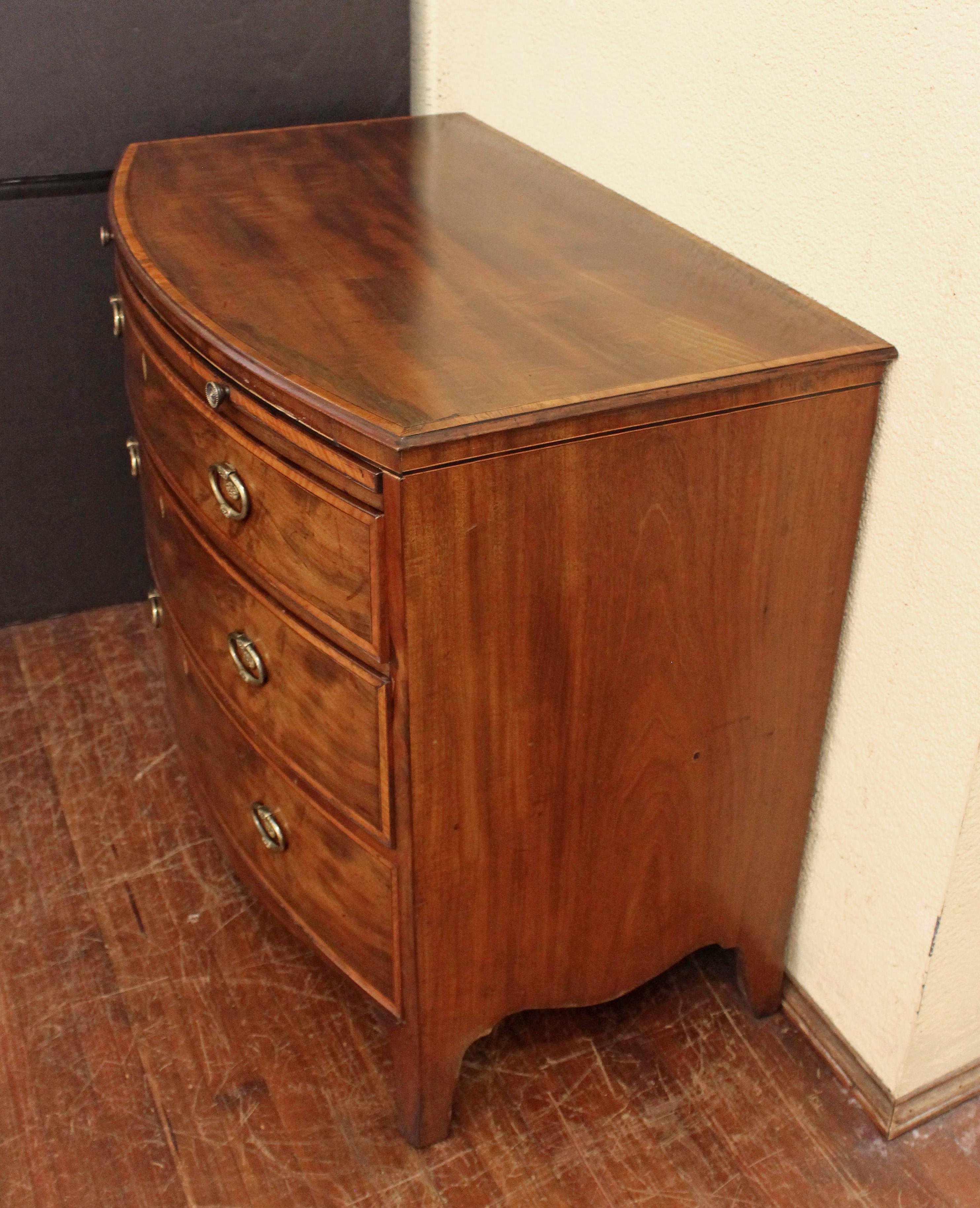 Circa 1770 bowfront chest of 3 drawers, attributed to Gillows, English. Brushing slide. Oval ring handles with rosettes typical of Gillows pieces. Shaped apron. Raised on French splay bracket feet. The shaped apron accentuating the bow of the piece.