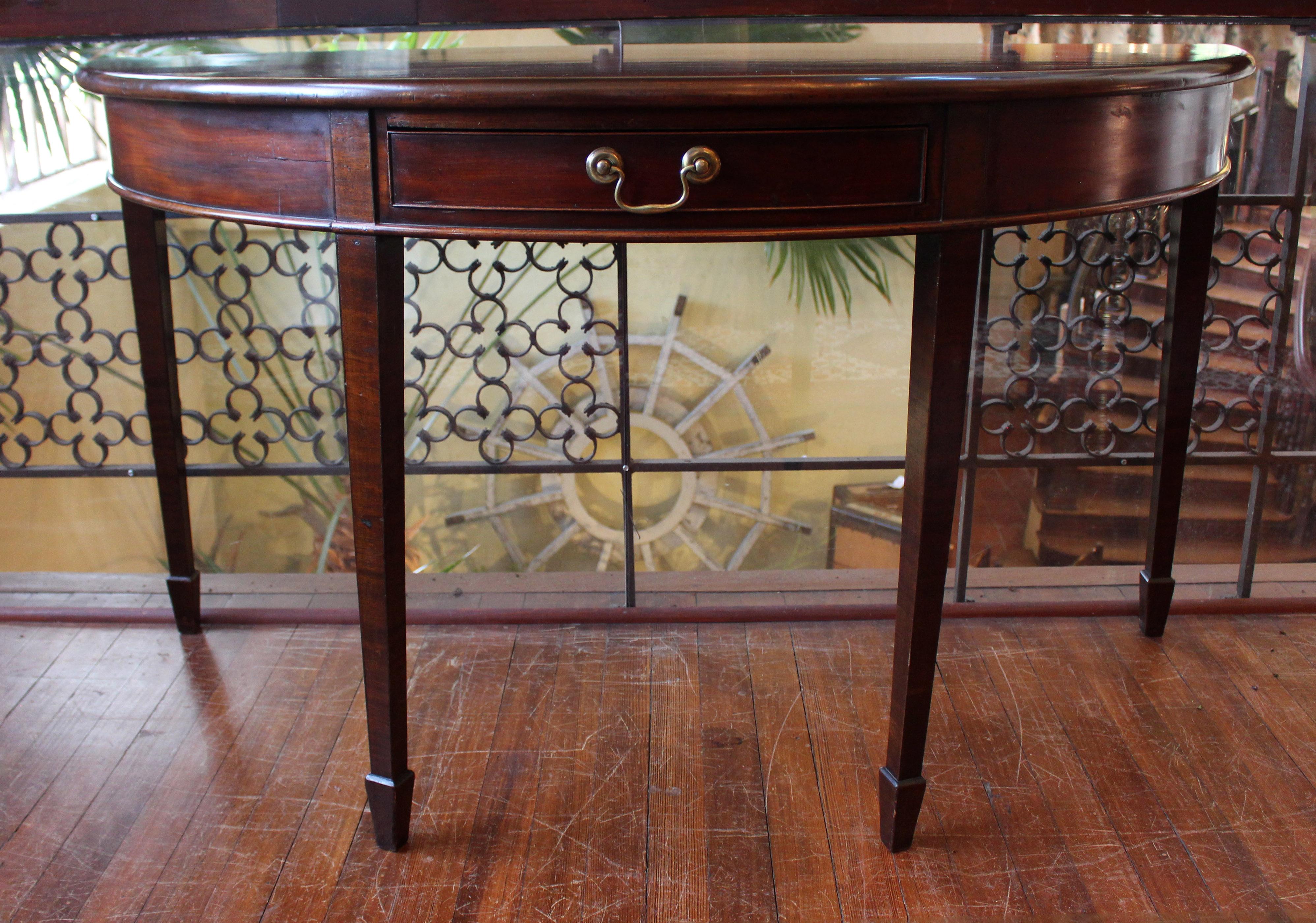 A Georgian demilune console table of grand size with an apron drawer. Mahogany. Quality blocked construction. c.1770, Neoclassical. Raised on straight, tapered legs ending in spade feet. Measures: 56 3/4