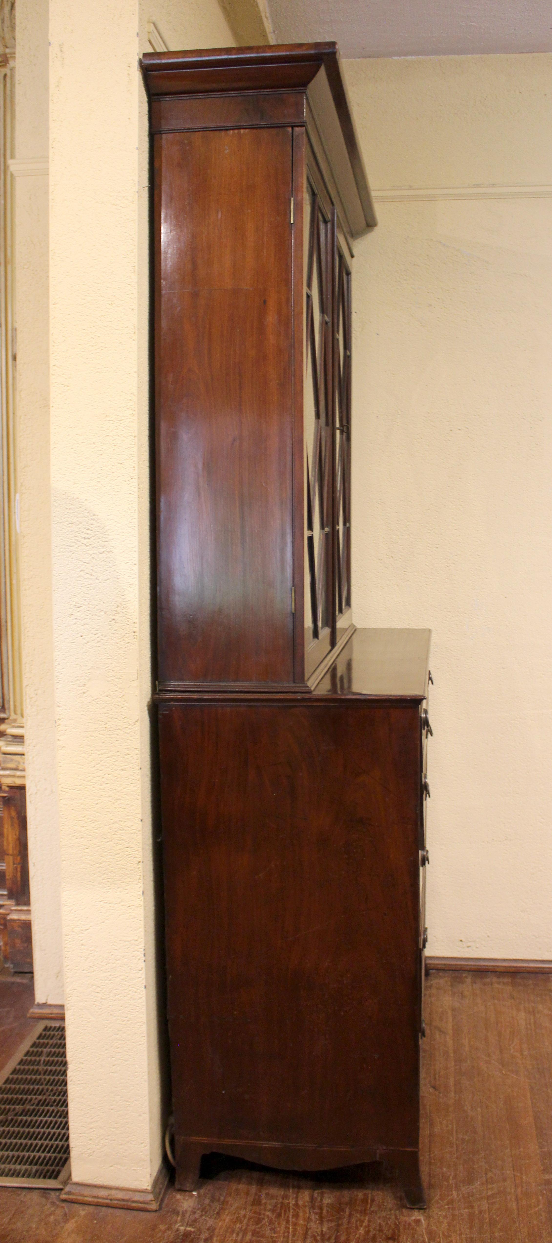 Circa 1780-1800 Georgian Secretaire Bookcase, English. Neo-classical taste. The base raised on French splay feet with scalloped, line inlaid apron. Shield escutcheons. The handsome interior includes leather book covered 