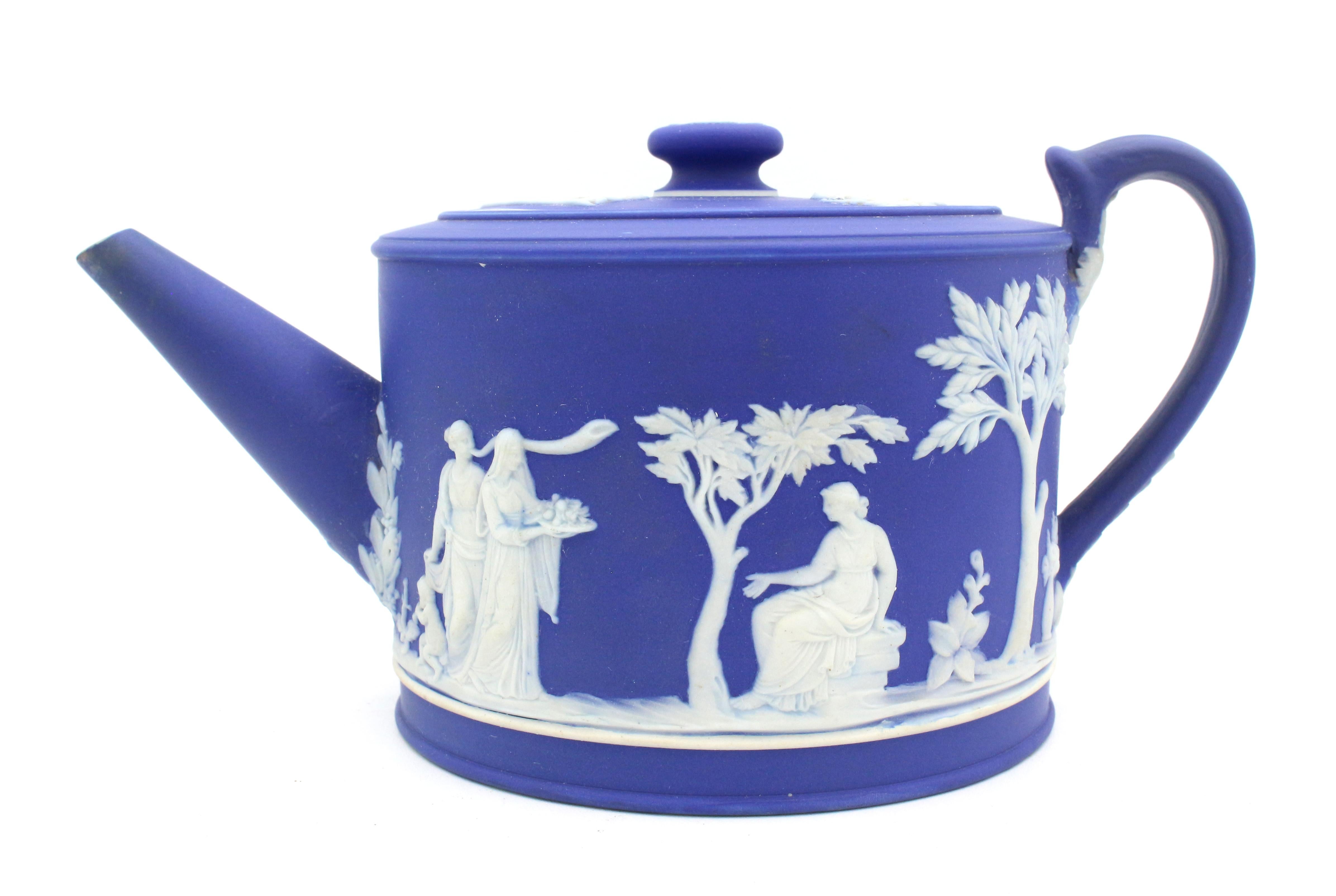 Circa 1780-1820 Wedgwood dark blue Jasperware teapot. Elegantly adorned with Greco-Roman scenes. Impressed Wedgwood. Provenance: Tudor House Galleries, Charlotte, NC, 1/21/90. Spout tip - old repair.
7.75