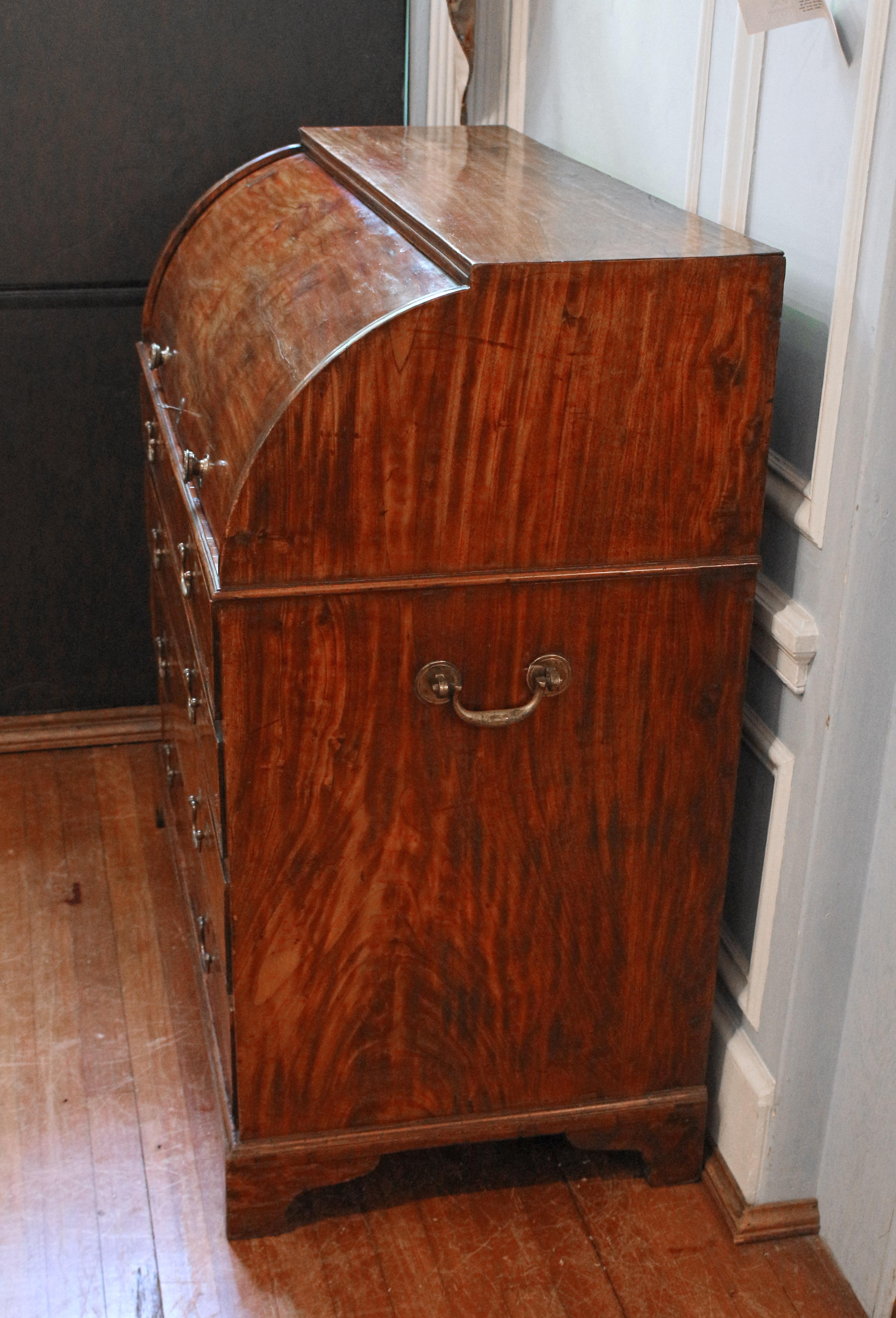 Chinese export solid camphor wood campaign bureau à cylindre or roll-top desk, circa 1780. An extremely rare example - entirely of beautifully figured camphor wood which has mellowed to a rich mahogany color over 250 years. Writing surface slides