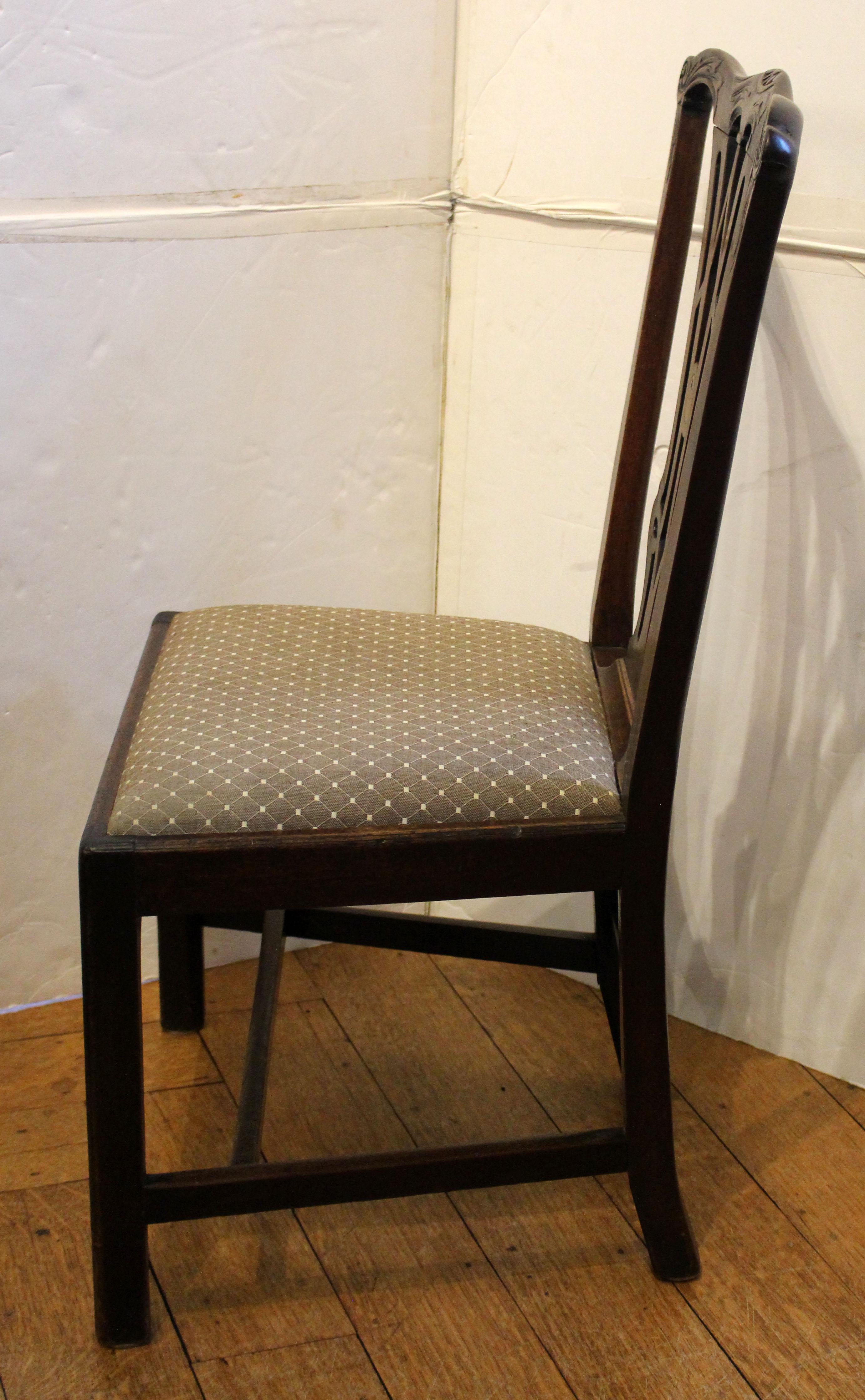Circa 1780 George III carved & inlaid side chair, English. Slip seat. Raised on square legs with stretchers. The back is superbly carved based on Chippendale Director designs. Central backsplat inlaid satinwood oval with boxwood checkered
