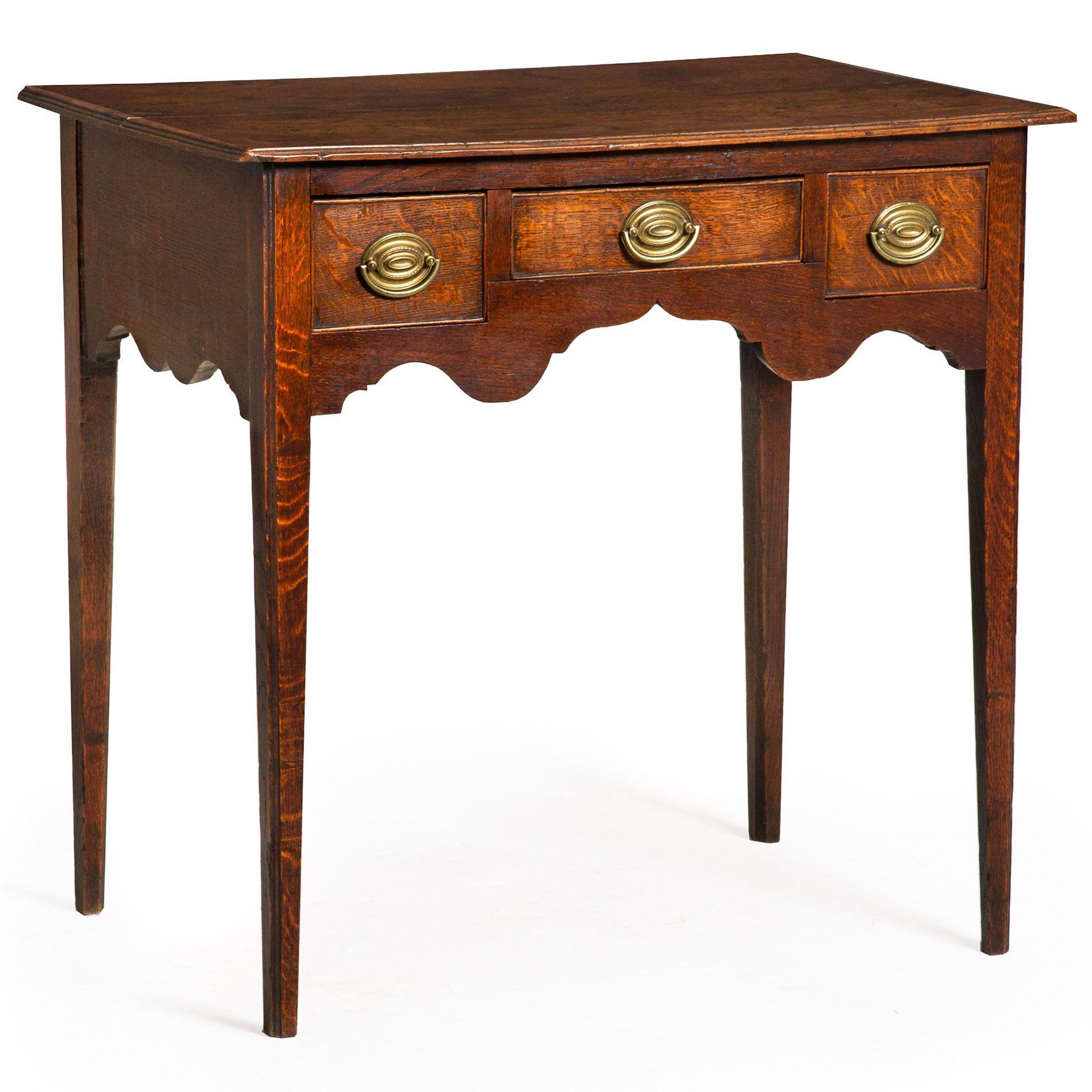 GEORGE III PROVINCIAL PATINATED OAK THREE-DRAWER WRITING TABLE
England, circa 1780  with scrolled cupid's bow apron
Item # 312EKH07Q

A beautifully patinated writing table from the George III period, this intelligently conceived and finely