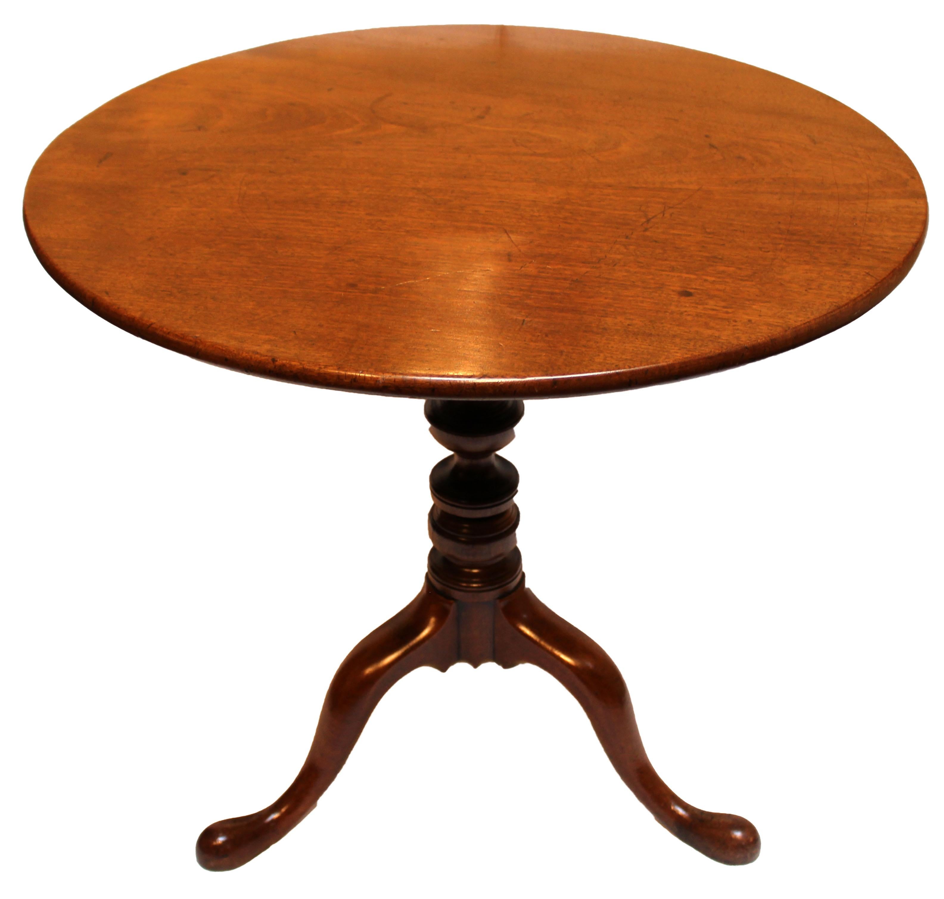 Circa 1780 George III period tilt-top tea table, English. Mahogany with fine figure to the top. Raised on very well turned pedestal ending in three shaped cabriole legs with pad feet. Ring & marks on top commensurate with age & use.
30.25