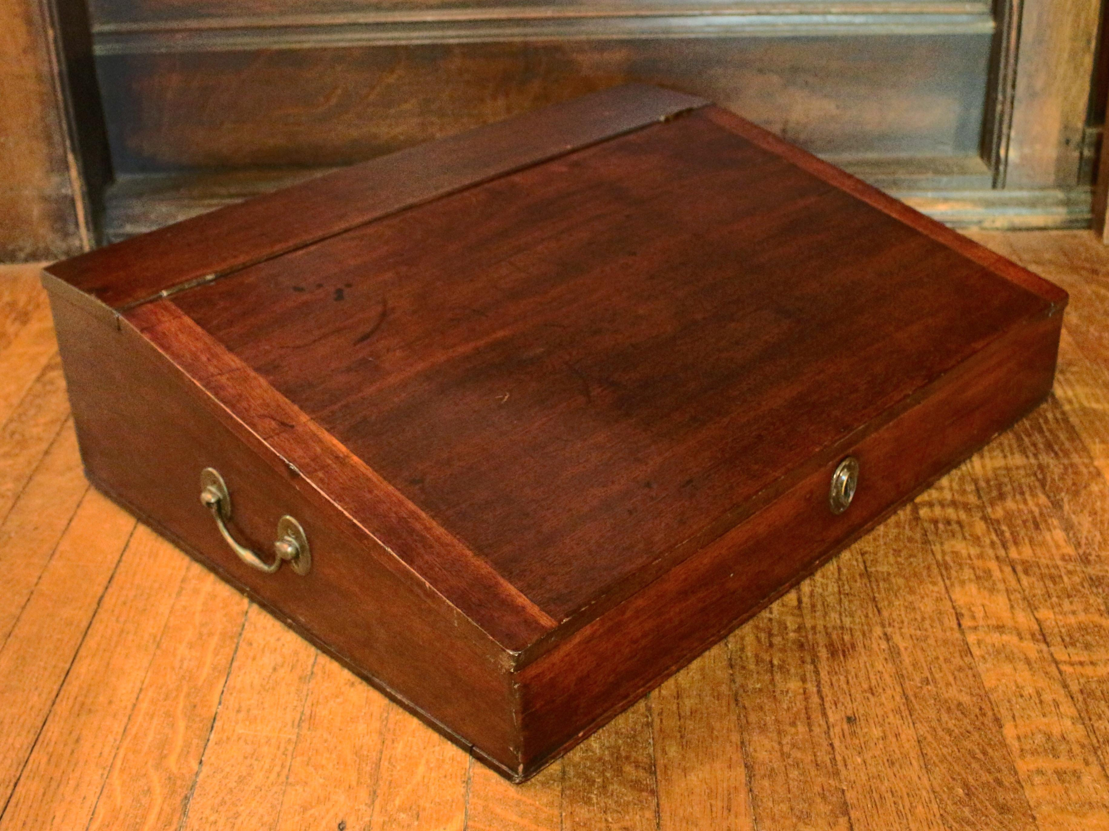 Georgian writing slope box, c.1780, of mahogany. English. Well fitted interior with pigeon holes, drawers, and two shaped supports for the slope. Apparently original hardware. 25