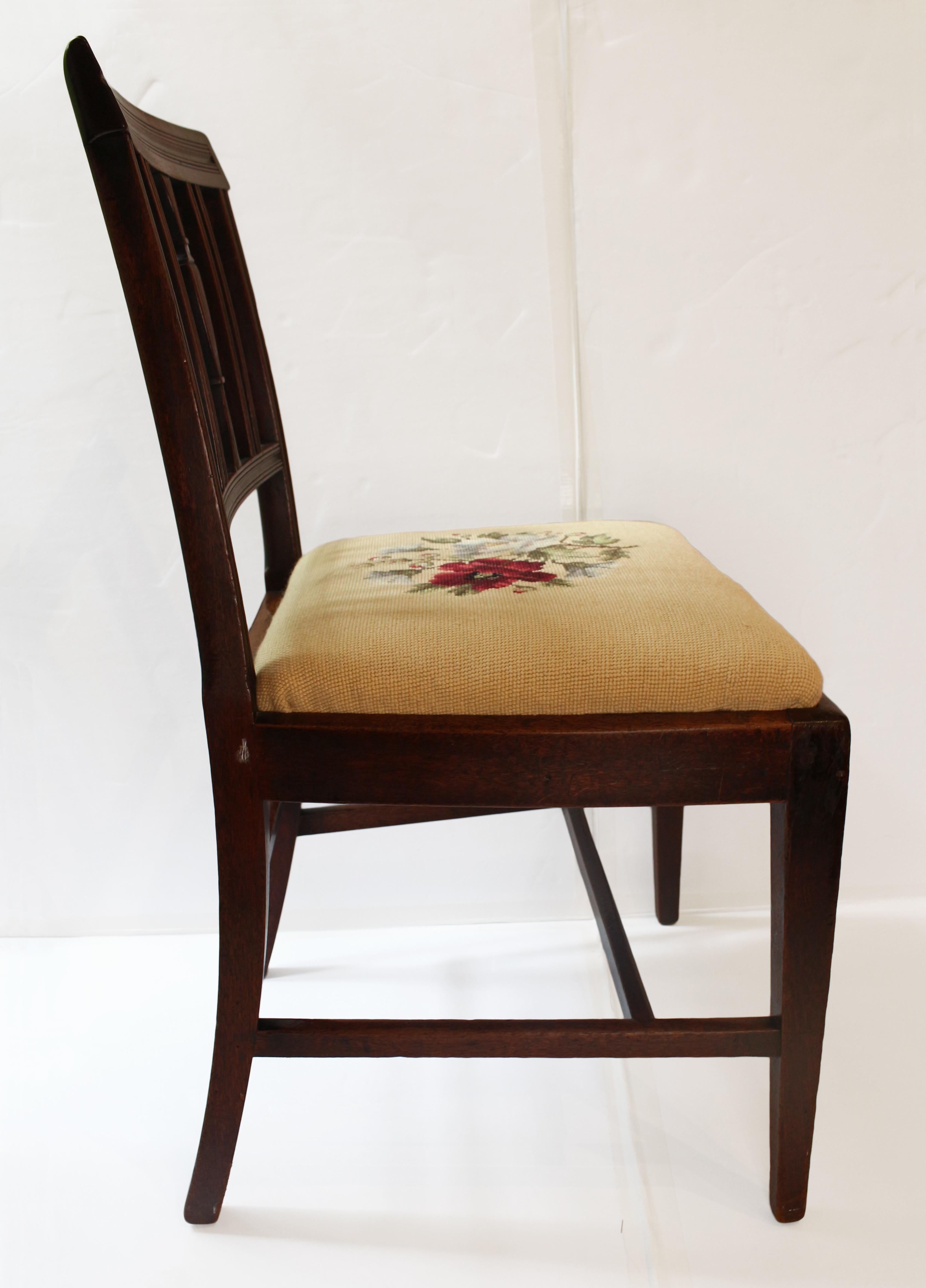 George III side chair, circa 1790 neoclassical design, English. Mahogany. Reeded back & stiles with central urn. Small flaw & repair to crest rail. Raised on square tapered legs. Slip seat with needlepoint upholstery.
20