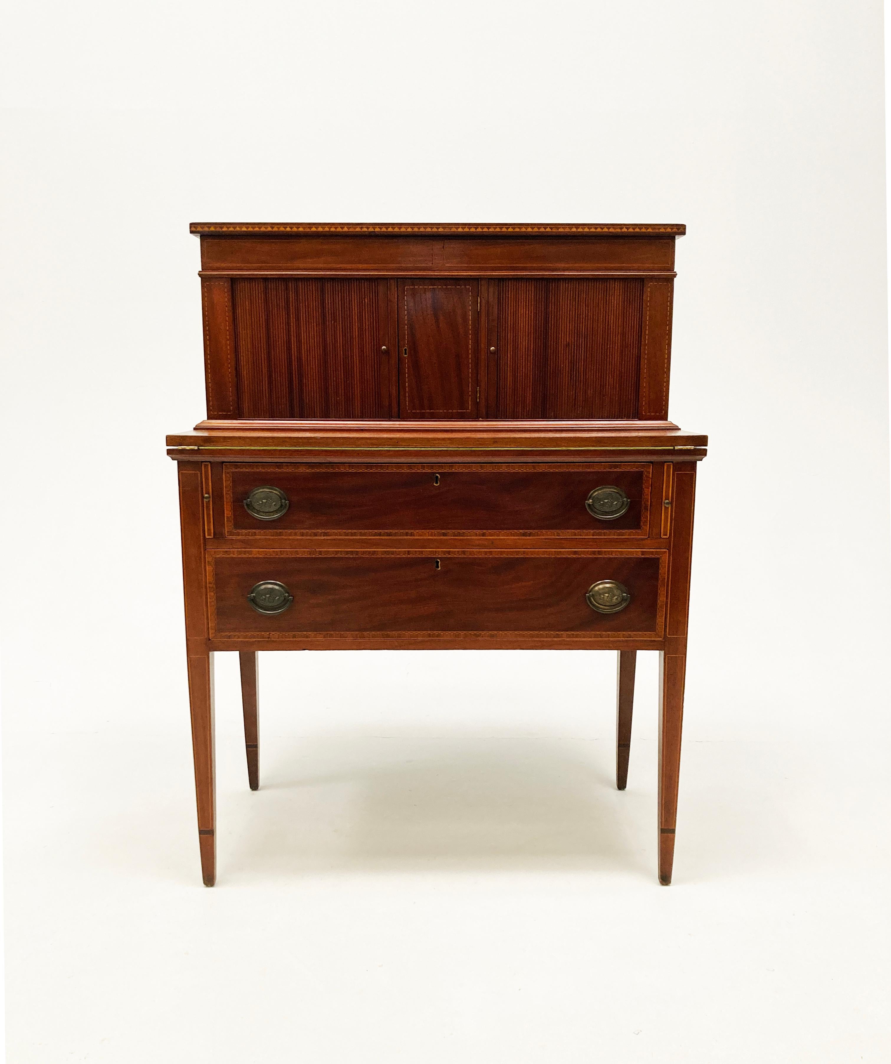 This stunning inlaid Mahogany Federal Hepplewhite Tambour Desk, most likely originated in the Massachusetts area between 1800-1805 time period. It is a stellar example of the craftsmanship of this era with its intricate inlay work as well as the