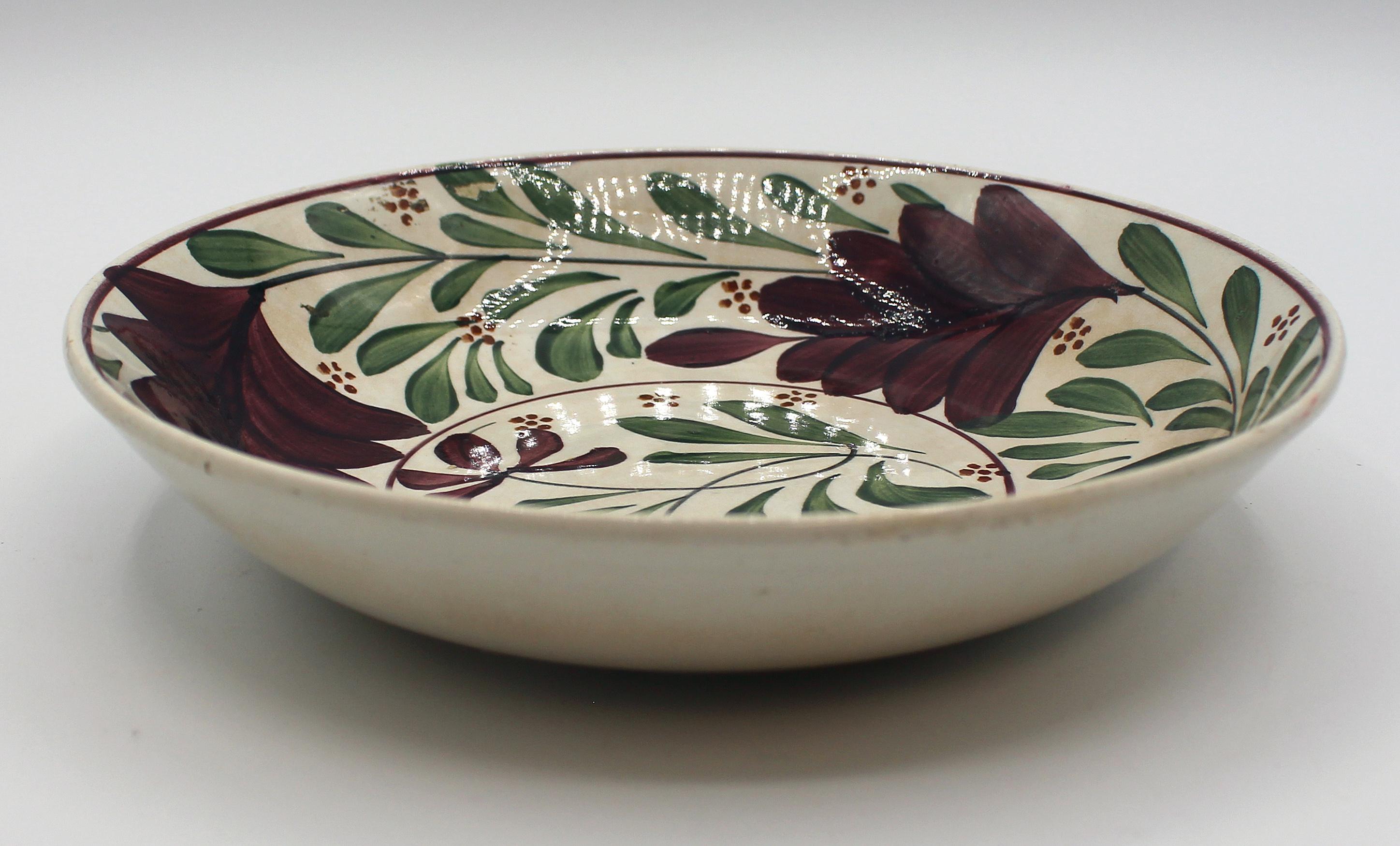 Circa 1800 English creamware bowl. Decorated with aubergine flowers swirling on stems of green leaves - bold & unusual.
8 3/8