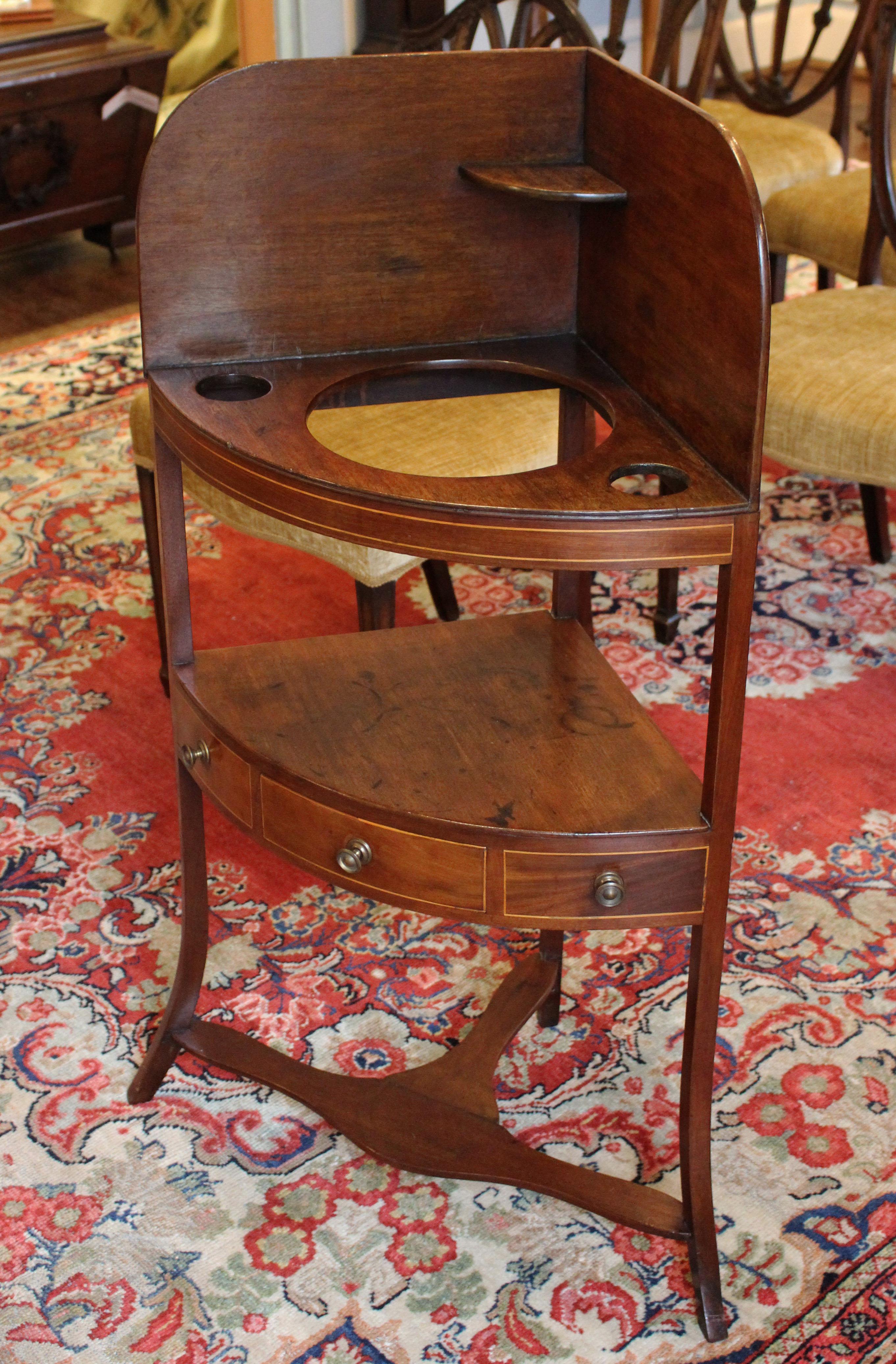 George III corner washstand, mahogany with boxwood inlays. English, c.1800. Raised on delicate, square, flared legs. Replaced pulls. 16