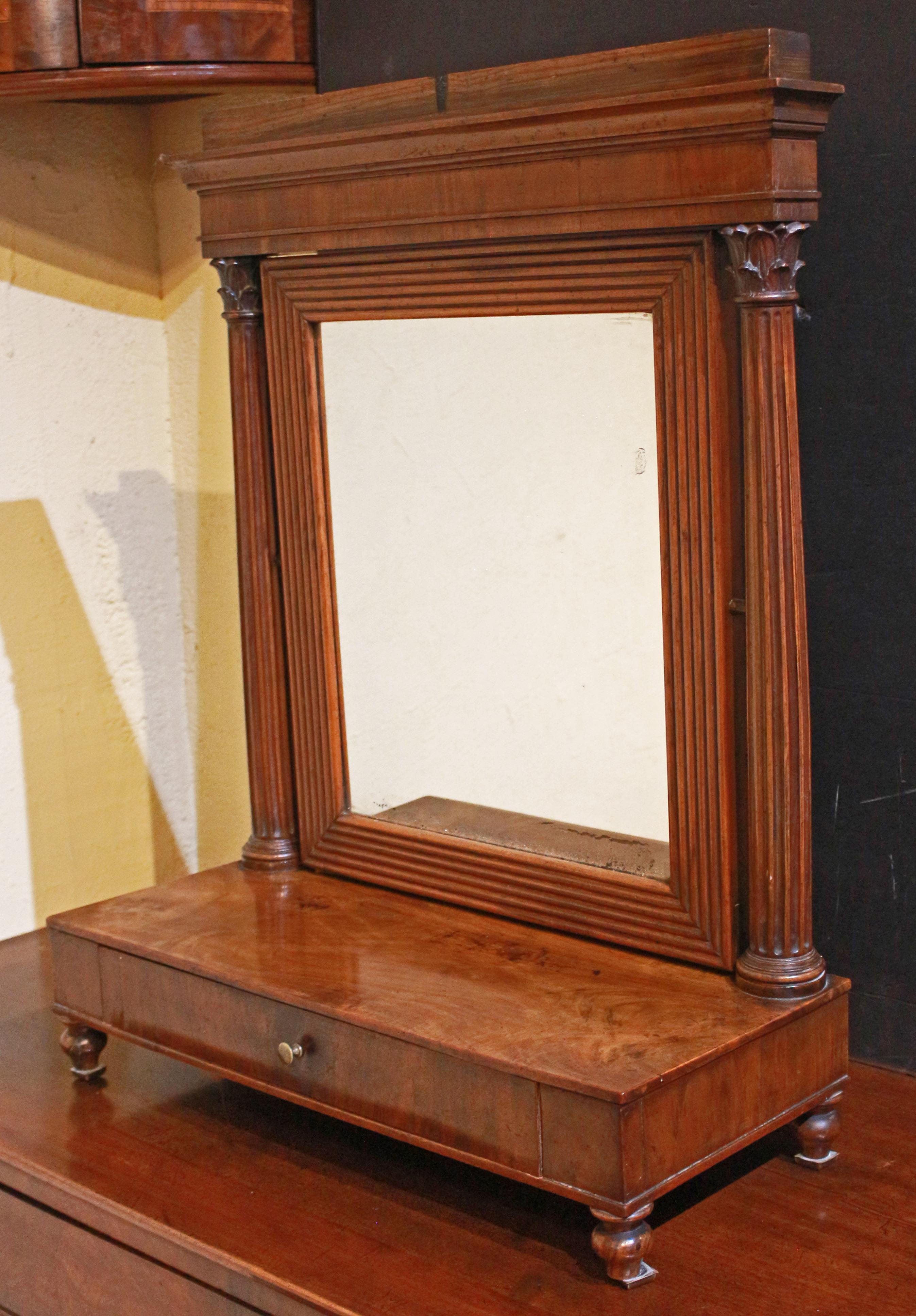 Circa 1800 Italian table top dressing mirror. Walnut & walnut veneers. Reeded mirror frame reflects the reeded Corinthian columns of the stand, raised on short, turned feet. Stepped, flat plinth top over cove molding. Single drawer with brass knob.