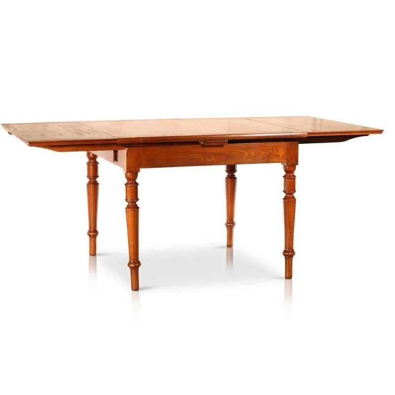 This exquisite Circa 1800’s Italian walnut extendable table features lovely Louis XV style columned legs and pull out underneath drawers. The top of the table folds out to a full size large dining table or alternatively, the table seats four people