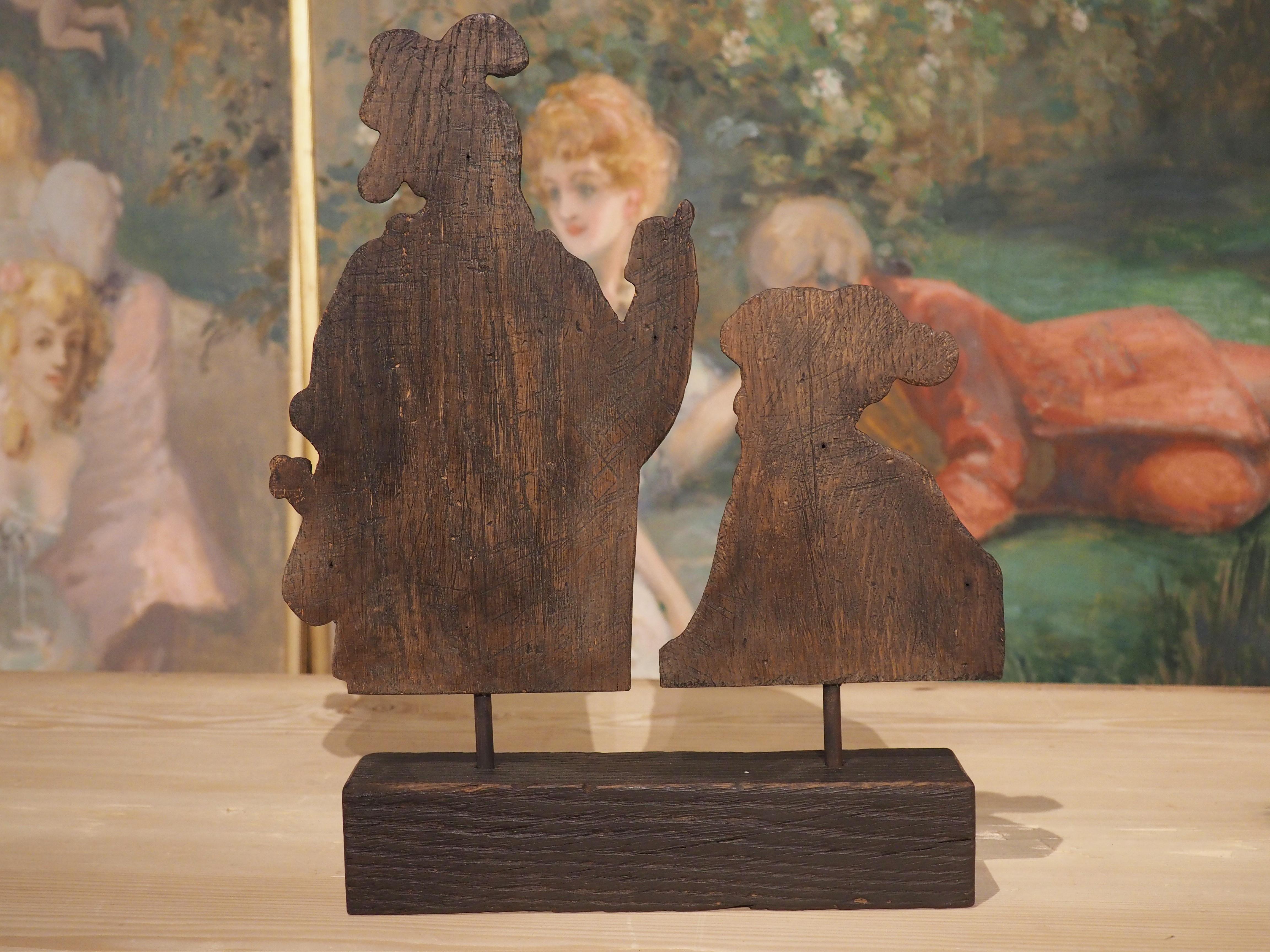 Originally part of a larger, carved presentation from Flanders (circa 1800), this pair of oak soldiers have been mounted to a two and a half tall block with a dark finish. The patina of the soldiers is a combination of brown and tan, making the