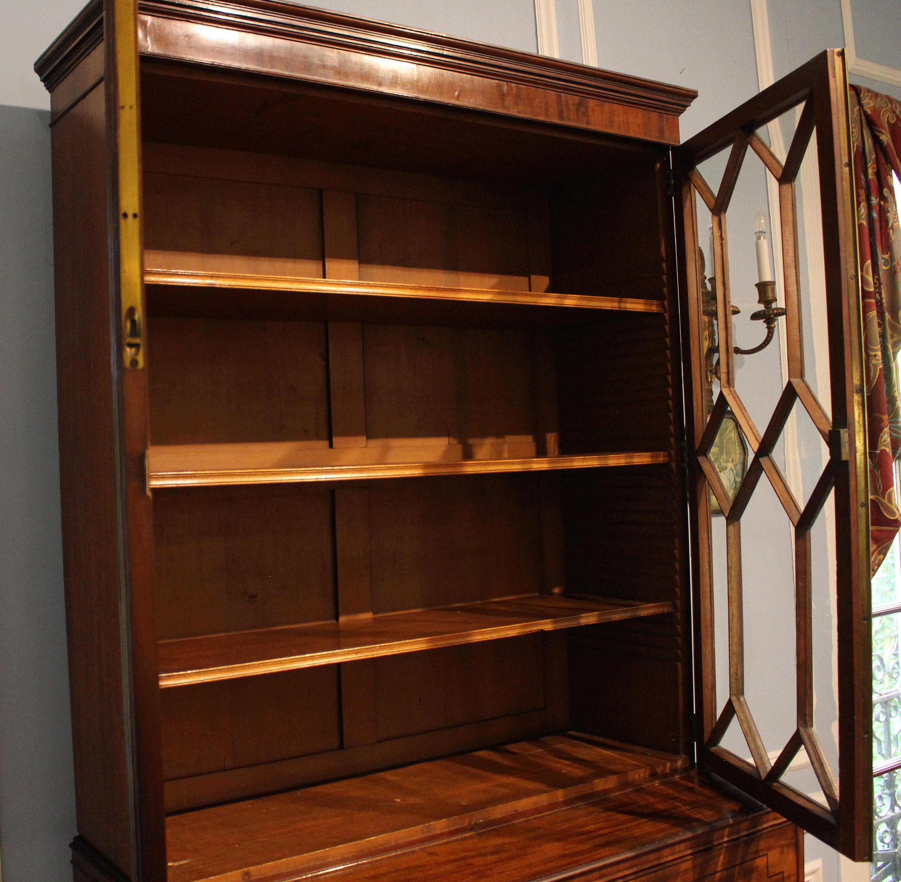 circa 1800 secretaire bookcase, English, George III-Regency. Mahogany; oak secondary wood; ebony accent molding & line inlays on the drawer fronts. Astragal glazed doors, 3 adjustable original shelves & paneled back construction. Crown molding with