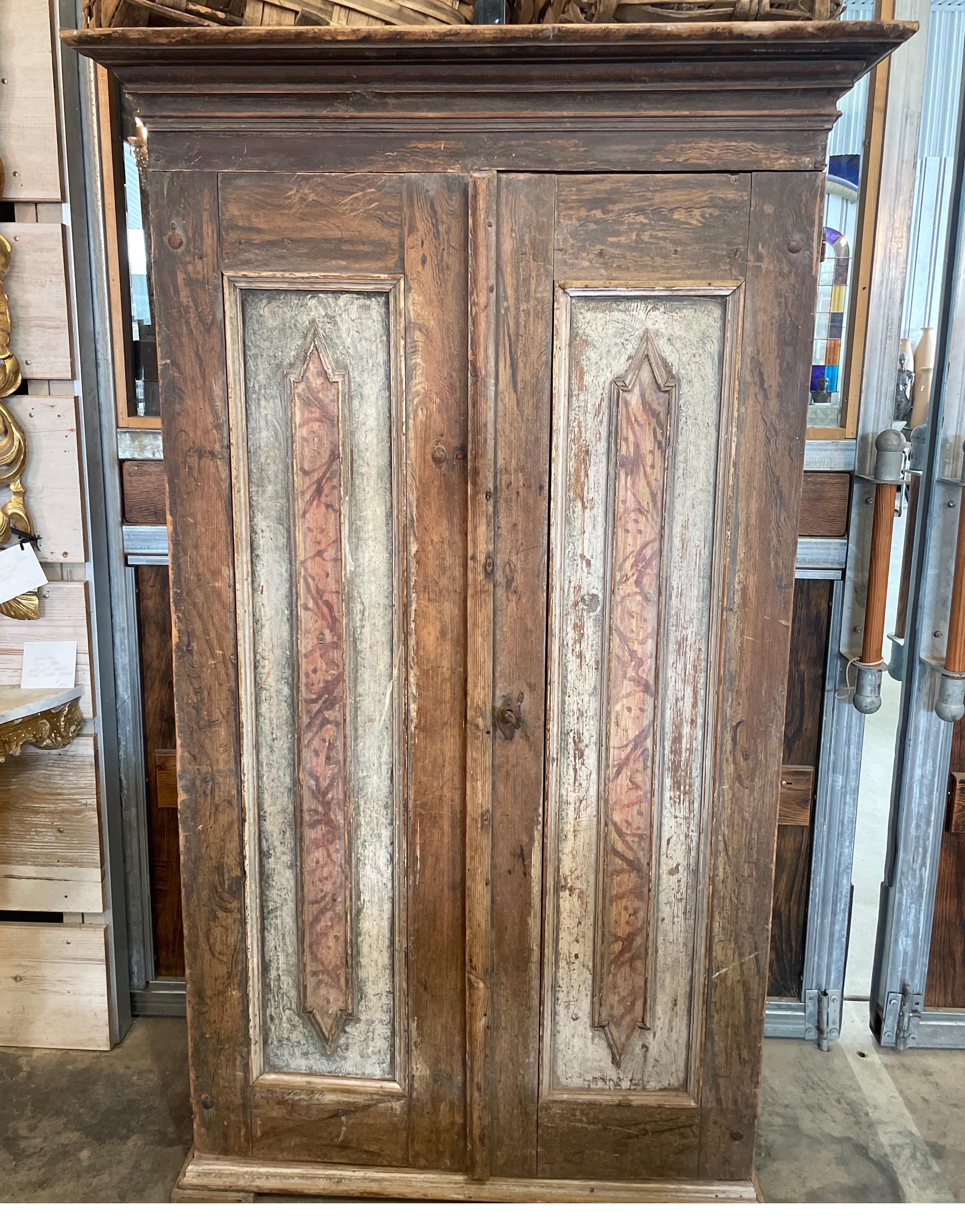 This is such a handsome painted cabinet originated from Sweden. It has amazing hardware and patina with faux marble paint all over.  It's outfitted with four built in shelves.  On the right hand side of the inside right door is the date 1800 faintly