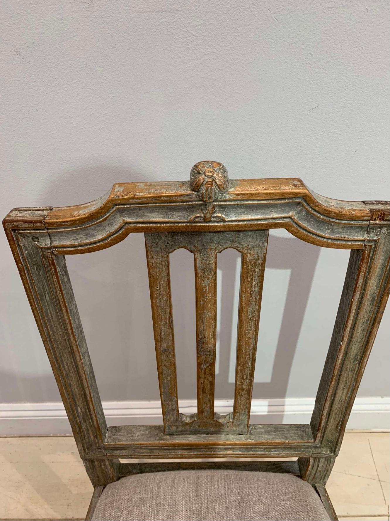 Deliziosa sedia svedese gustaviana dipinta della fine del XVIII secolo. 
La sedia conserva gran parte della vernice originale e presenta un fiore decorativo in legno intagliato nella parte superiore dello schienale, mentre la seduta a ribalta è