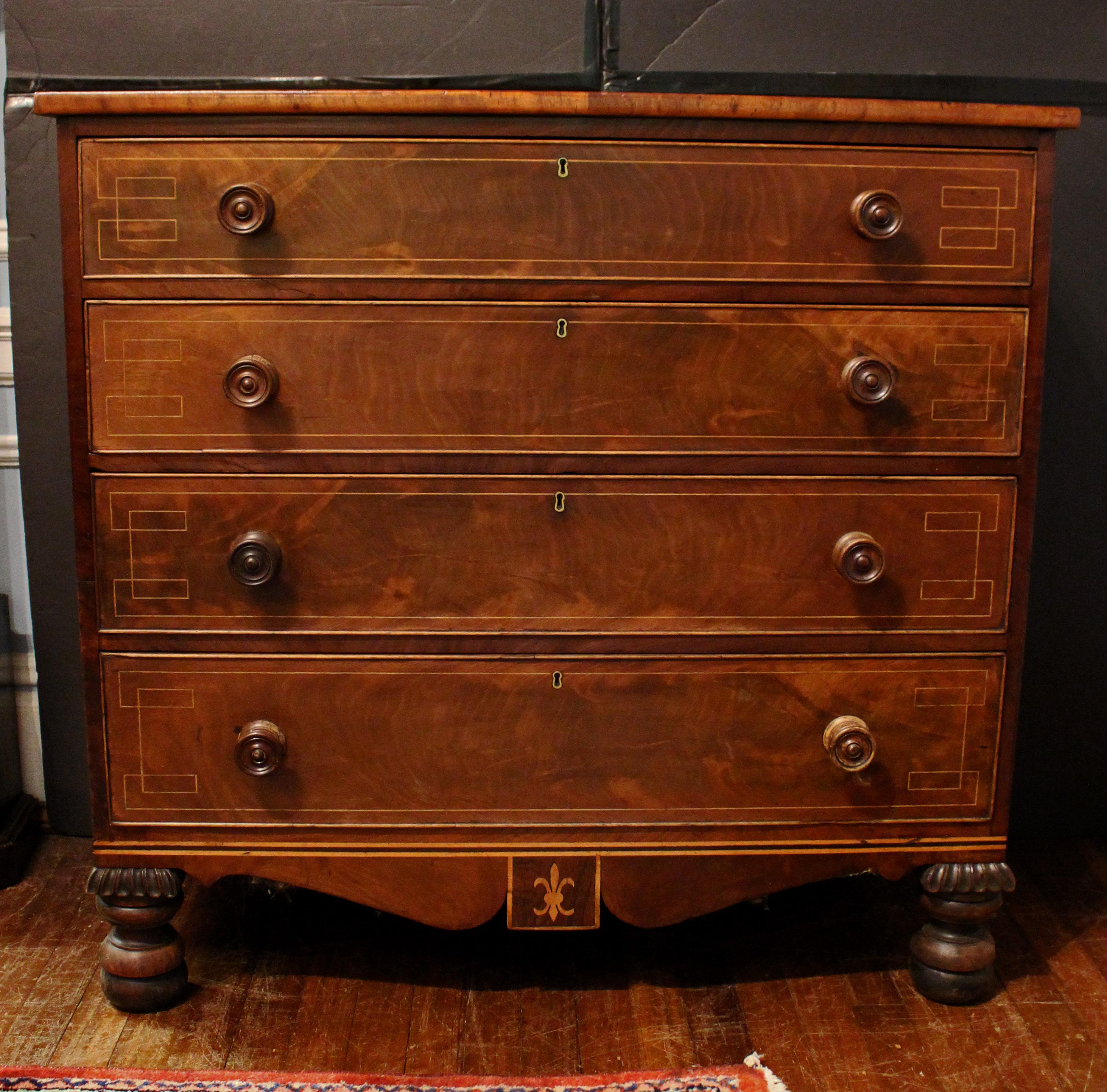 Circa 1810 Channel Islands 4-drawer chest of drawers, English. Mahogany. Chestnut drawer lining, typical of Channel Island construction. Charming design with 4 long graduated drawers each with elongated Greek key stringing (also on the top) over