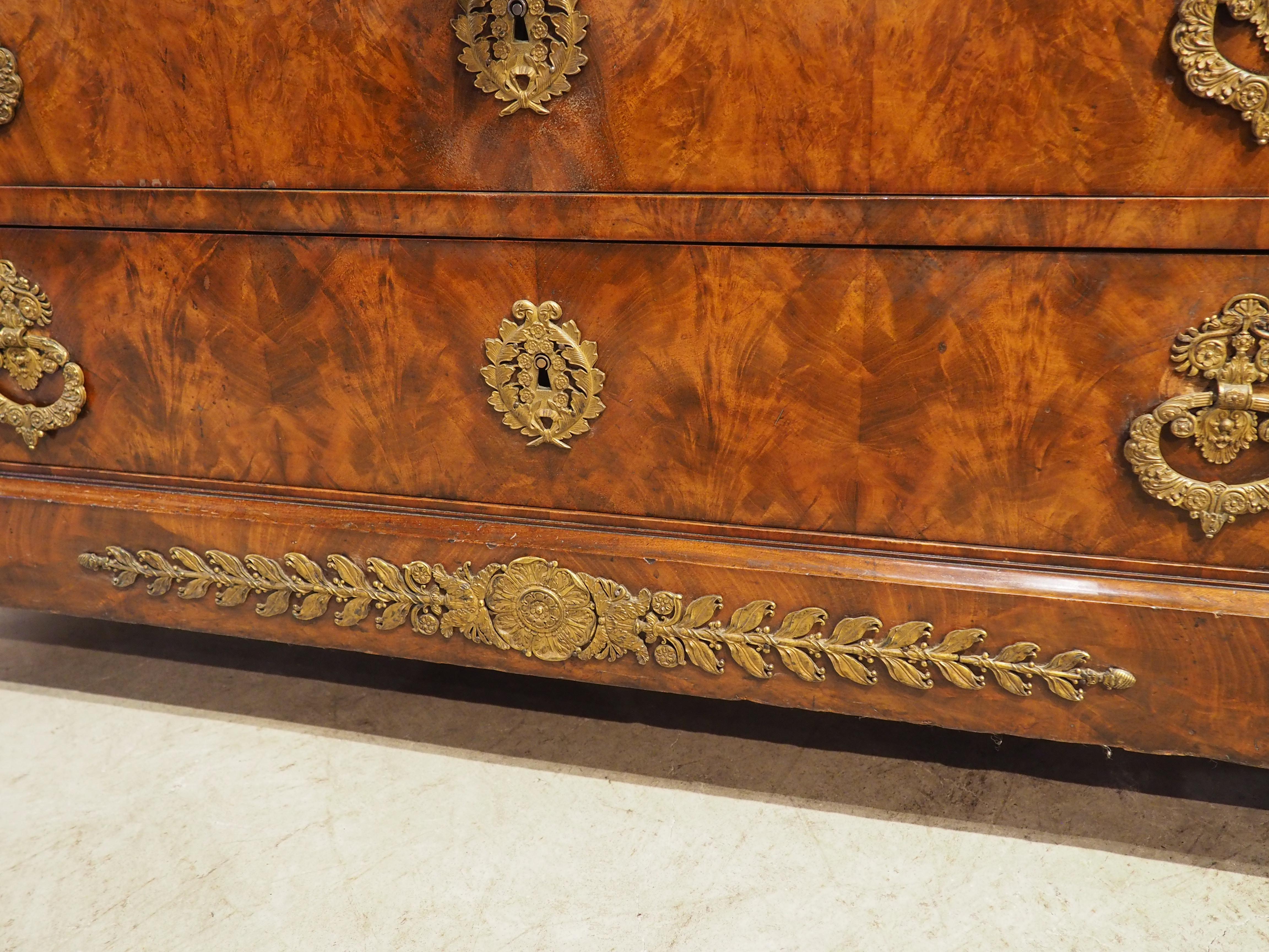 Hand-Carved Circa 1820 French Restauration Commode in Flame Mahogany, Gilt Bronze Hardware For Sale