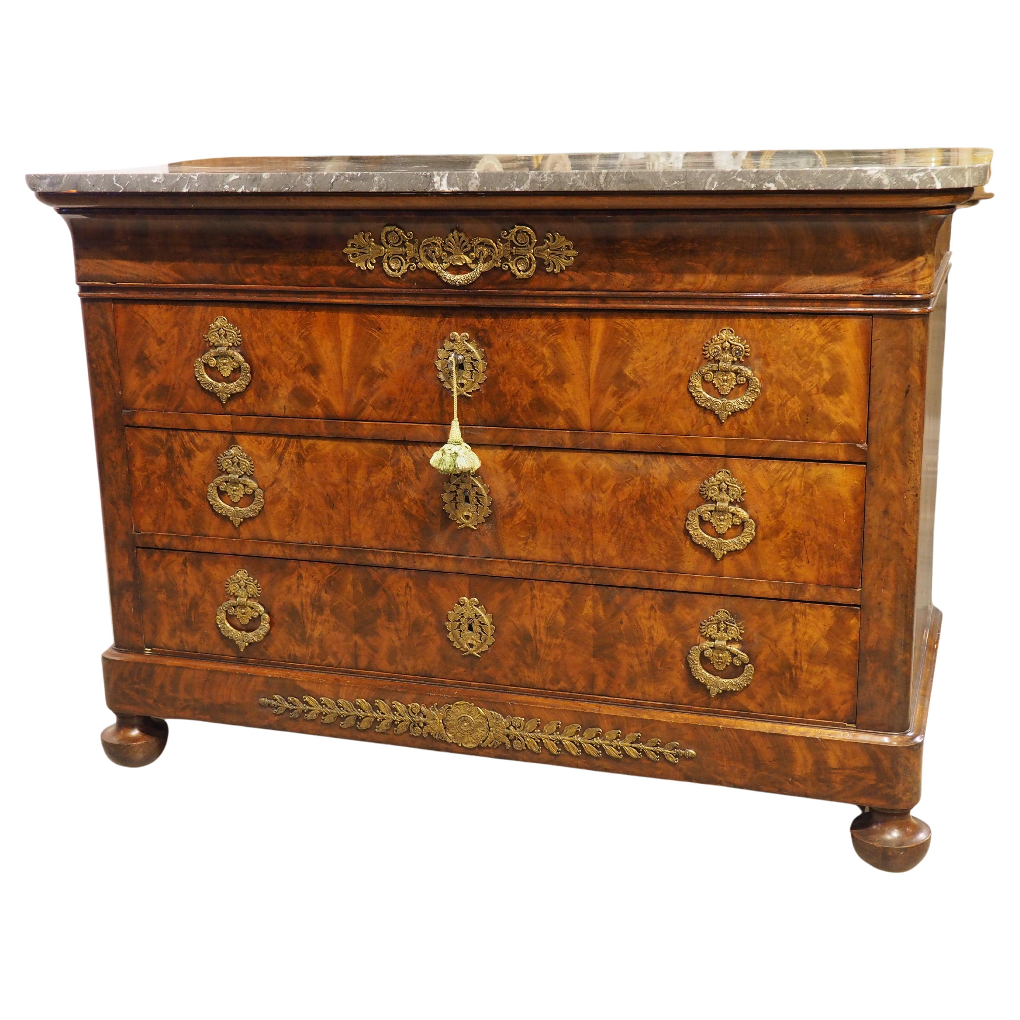 Circa 1820 French Restauration Commode in Flame Mahogany, Gilt Bronze Hardware For Sale