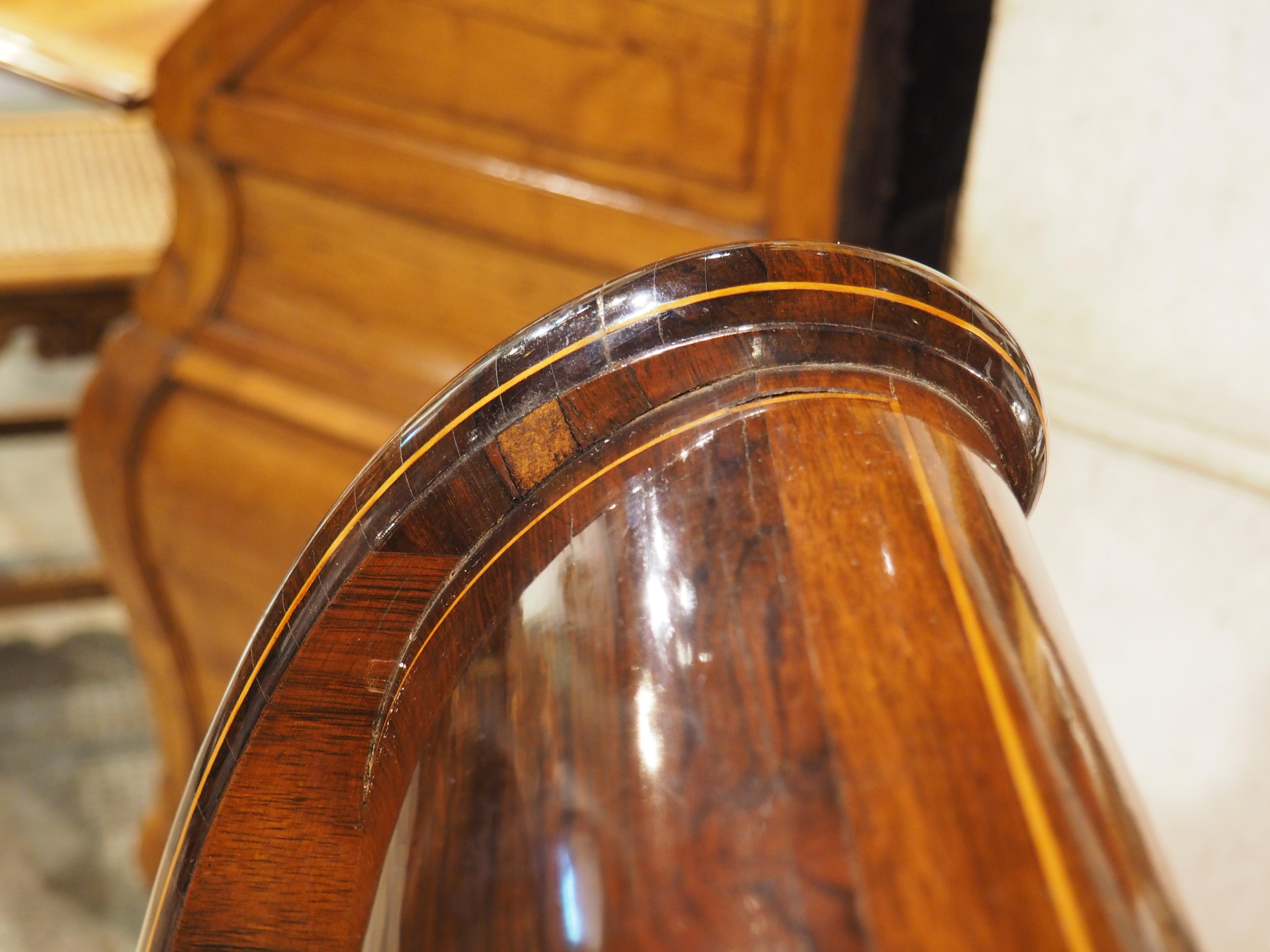 Dating to circa 1820, this beautiful sleigh bed and matching chevet side table were hand-carved during the French Restauration period. Both pieces have a wonderful spalted wood veneer (although the graining is more pronounced on the bed) that is a