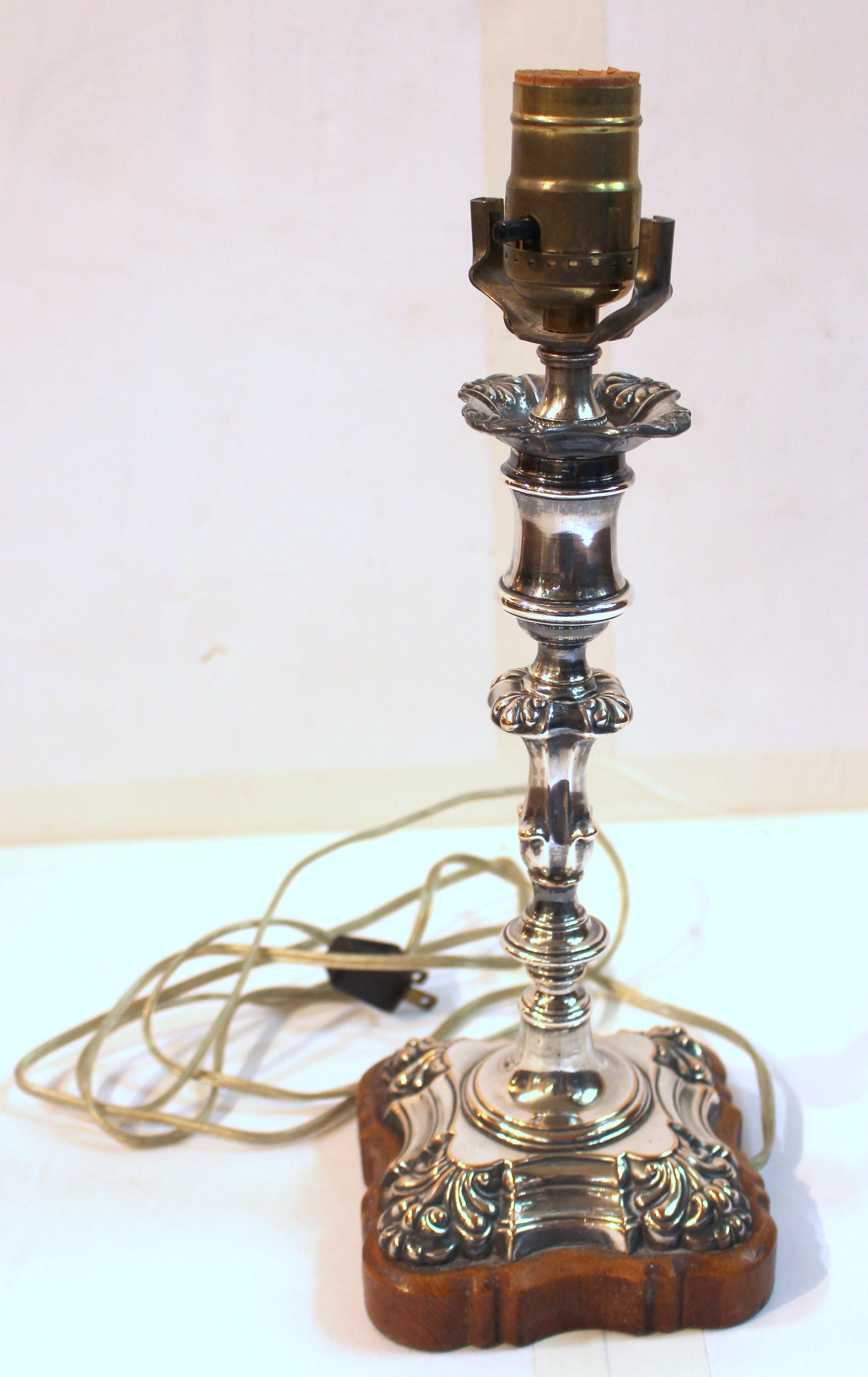 Circa 1820 Old Sheffield plate silver candlestick now as a lamp. Rococo revival design. Originally electrified in England on a custom conforming oak base. Lamps Ltd of Durham refitted electrification to US standards.
13 1/4