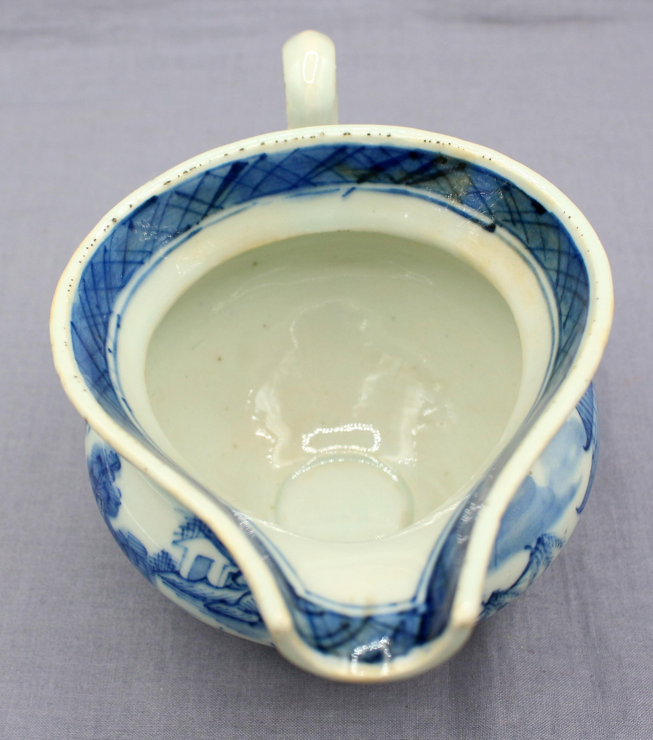 Circa 1830 Blue Canton gravy boat, Chinese export porcelain. Helmet form; loop handle. Light blue color. Interesting glaze & kiln flaws.
7