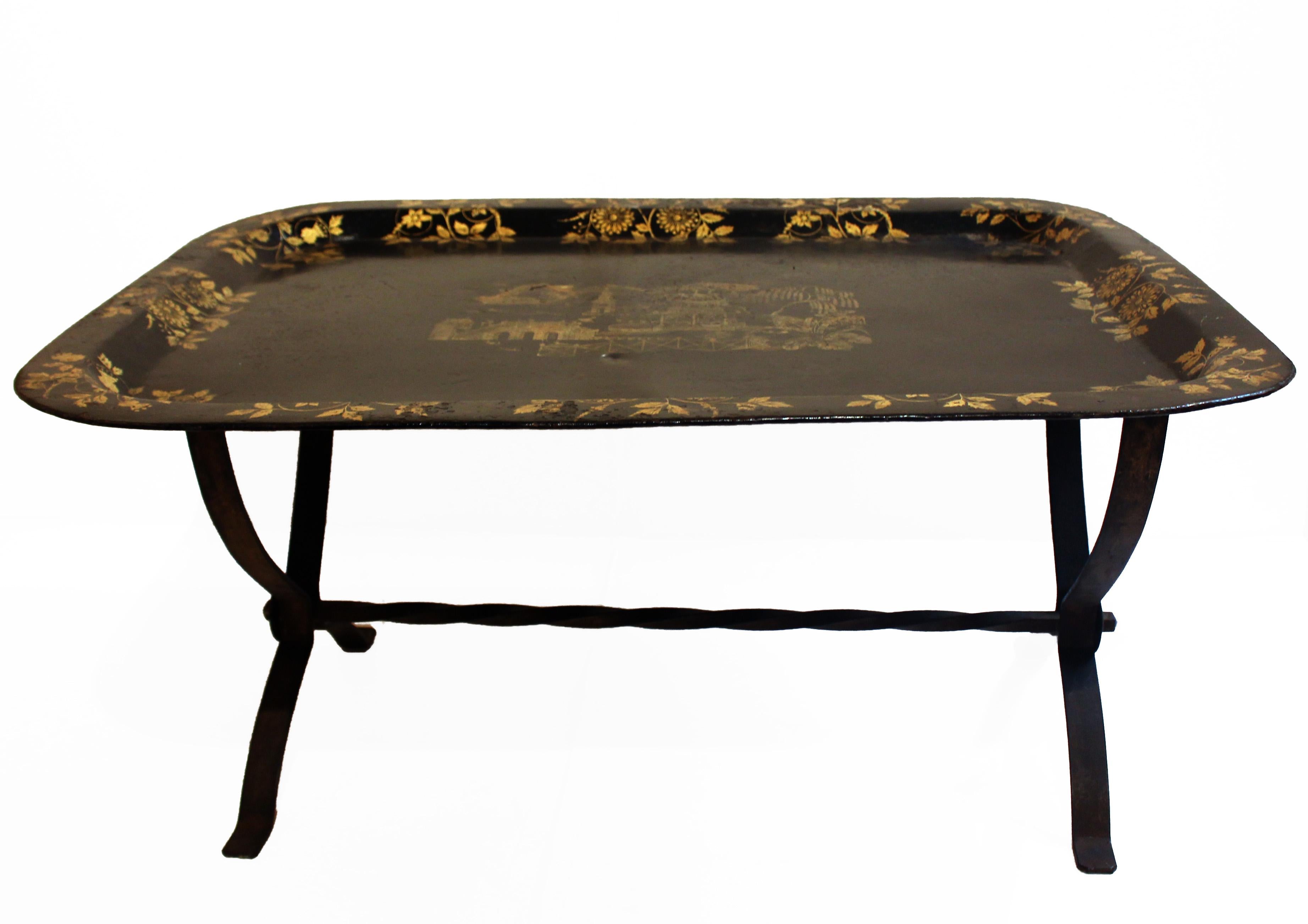 A large c.1830 English Tole Tray - the gilt chinoiserie decoration on black ground in fine unrestored condition. Now on an interesting steel stand of cerrule form made in the 1930's.
33 3/4