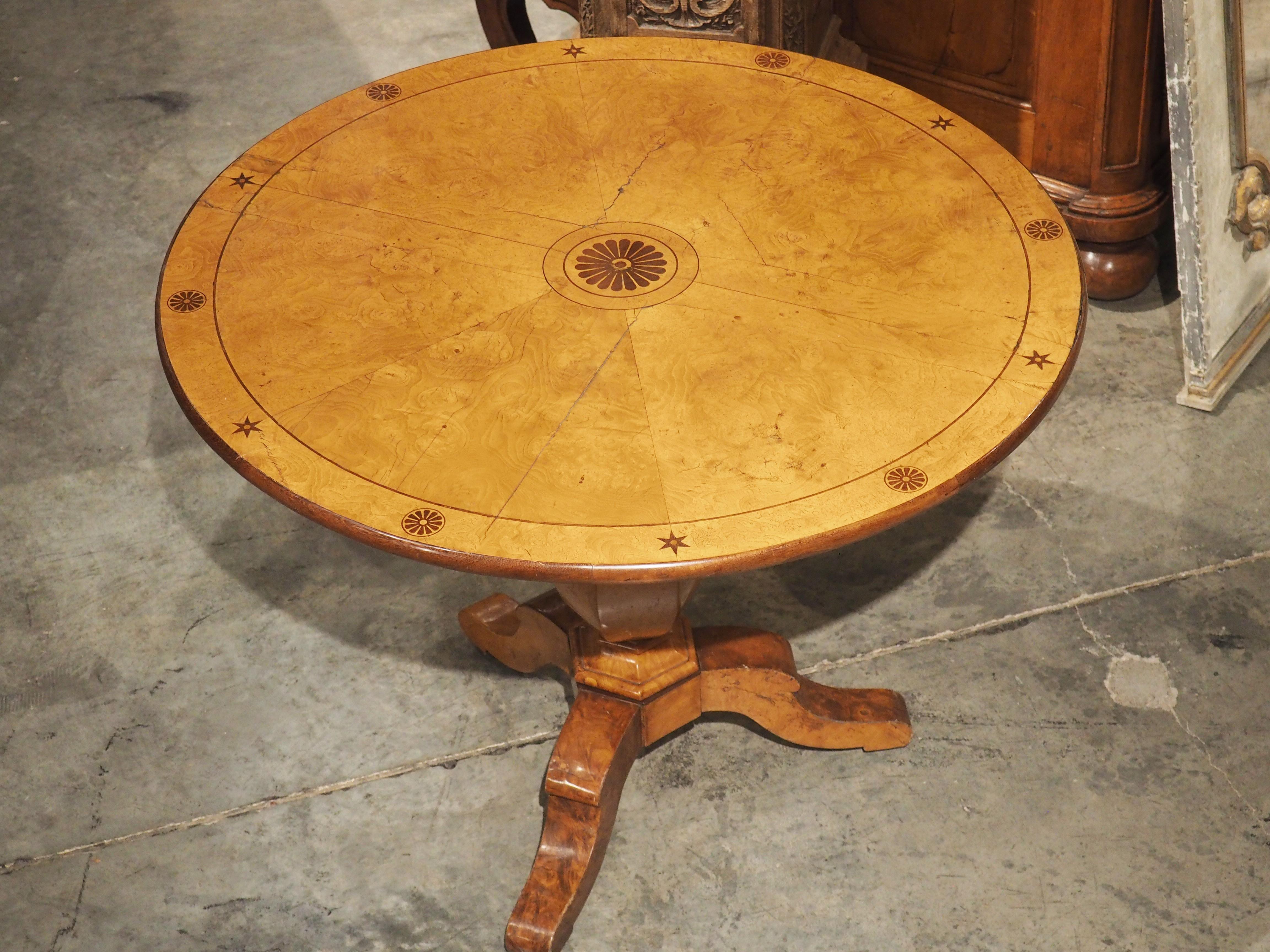 Hand-carved circa 1830, during the Louis Philippe period, this tilt-top table from France has a gorgeous light brown tone with yellow accents that is typical of the lemonwood tree. The wood, which was initially imported from Central America, has