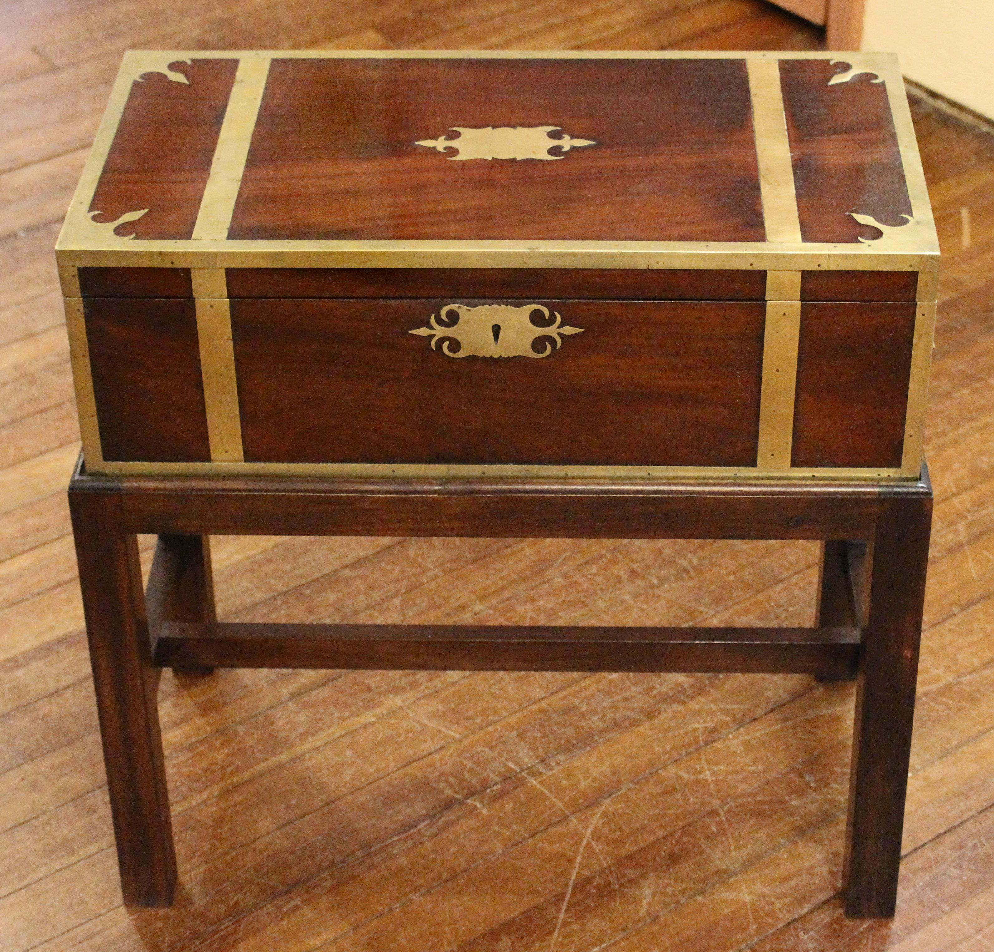 Circa 1830 George IV-William IV walnut brass bound & strapped lap desk, now on custom made stand as a side table. Shaped brass escutcheon, handles & engraving plate (never engraved) pick up the corner motifs of the top. A very high quality & fine