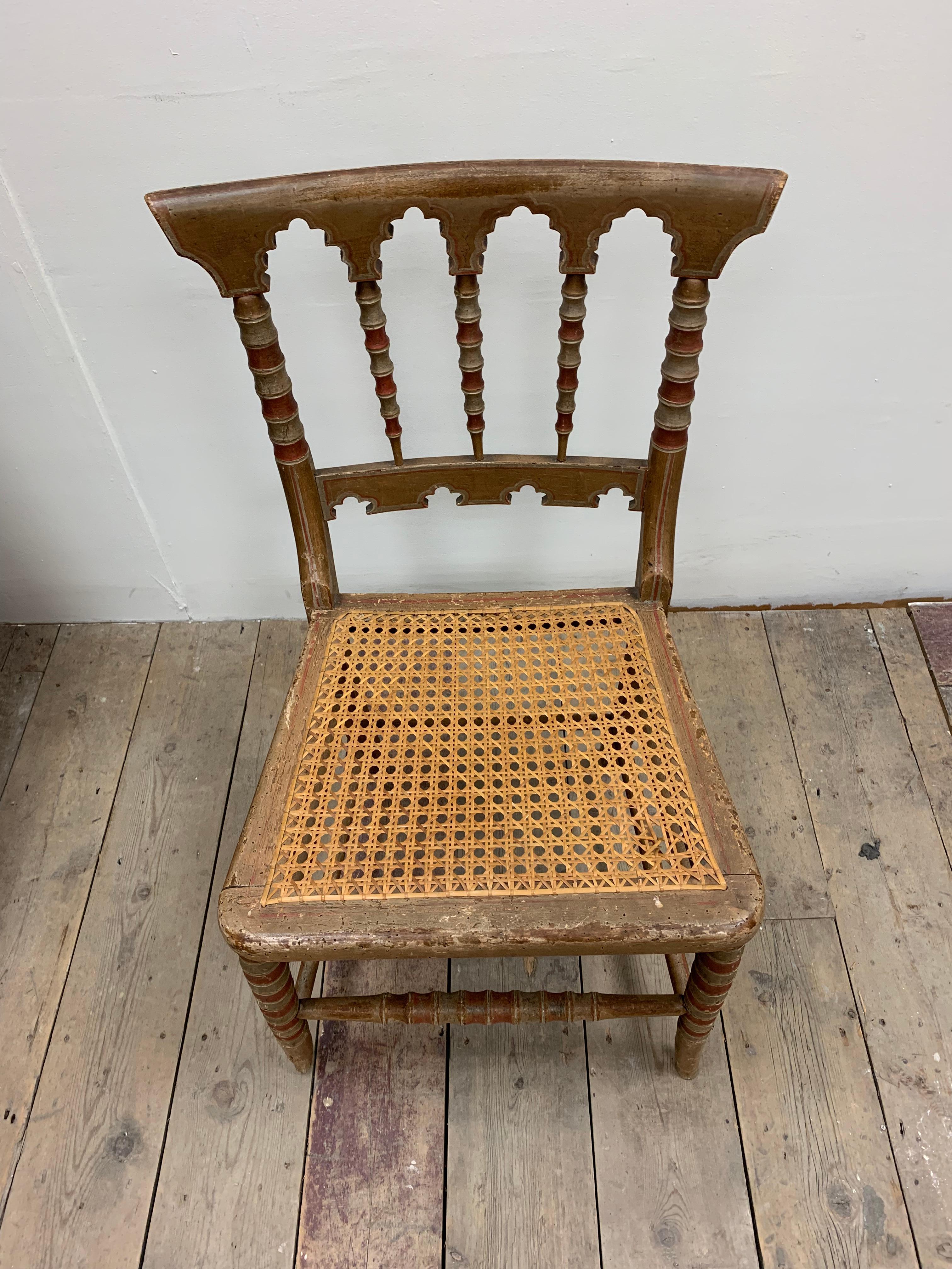 A lovely small painted and unusual English side chair.
Circa 1830s it has a canned seat (small damage to weave)
And Moorish architectural styling.

Good for a bedroom or bathroom.