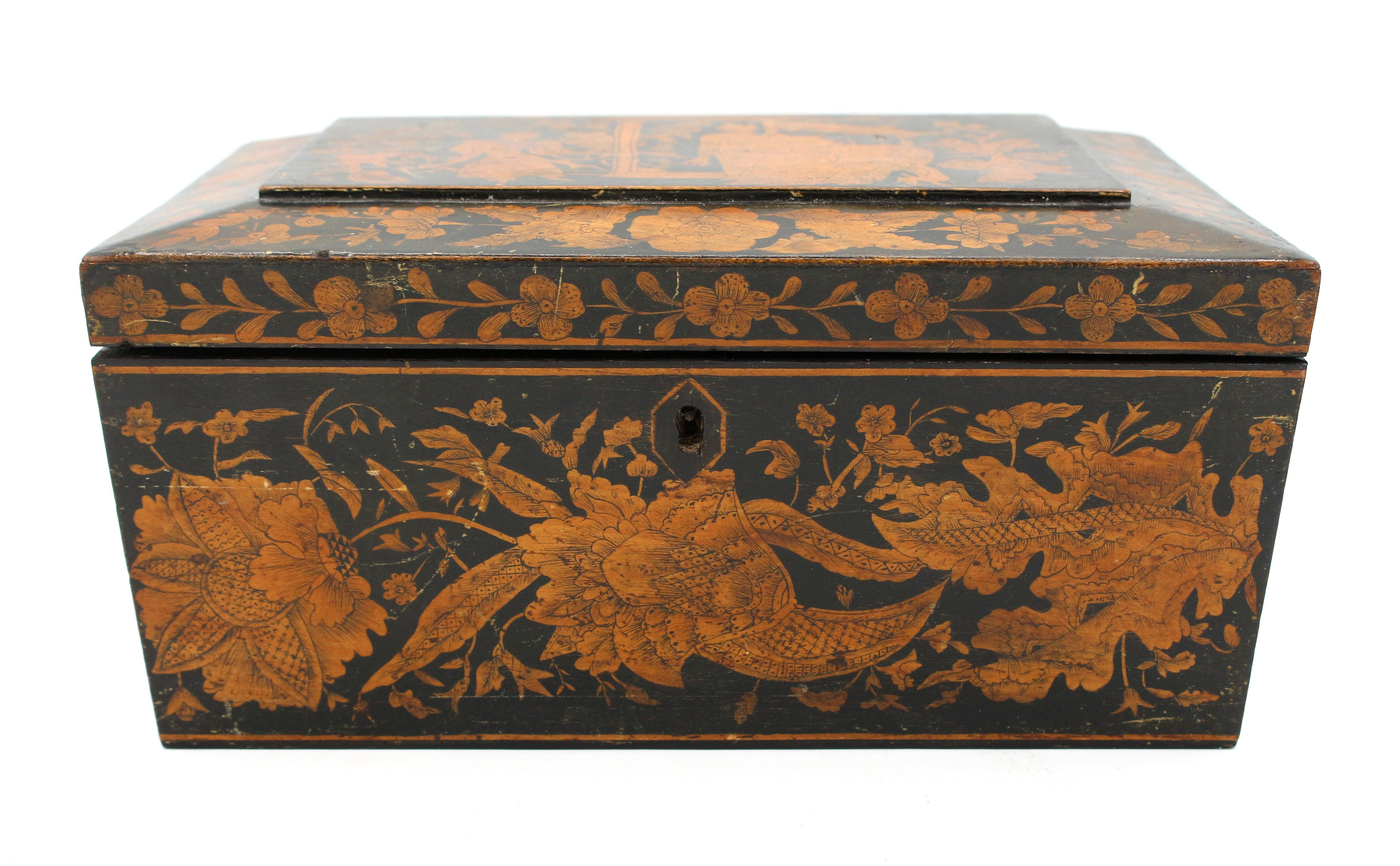 Circa 1830s English penwork box, Regency to George IV. Sarcophagus form; decorated with a large Asiatic panel with floral sides & borders. Replaced lion mask ring handles. Lacks interior jewelry tray & ball feet. Scuffs typical of this delicate form