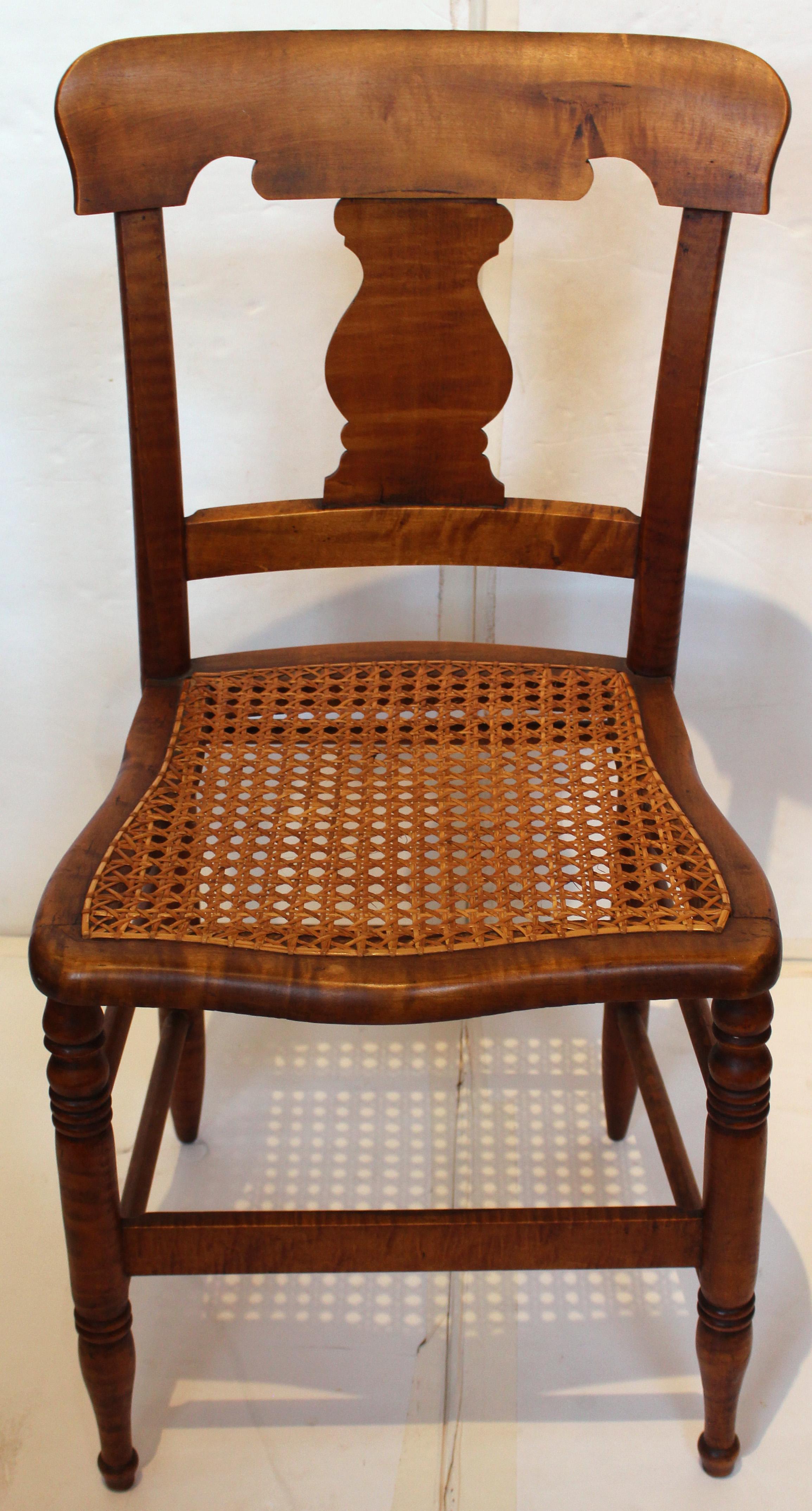 A fine set of 6 American late Classical period tiger maple side chairs, c. 1835. New England origin. Raised on ring turned, tapered legs with vasiform terminals. Cane sears in excellent condition. Great wood and warm color. 17 1/2