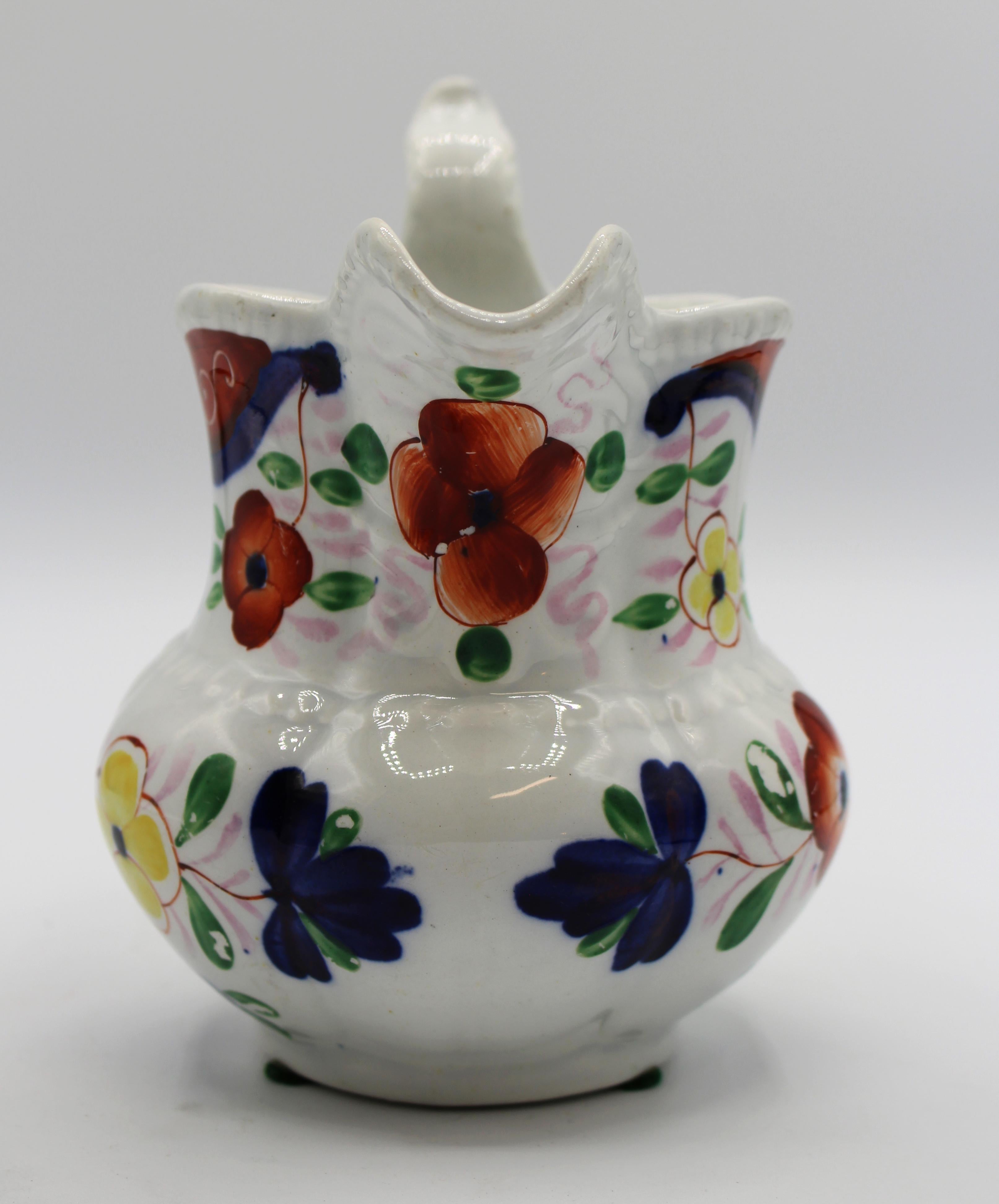 circa 1840 Gaudy Welsh pearlware jug with double-S handle & bold spout. The whole with gadroon borders. Drapery & cornucopia are in cobalt underglaze with flowers of yellow & orange. The handle has tiny rubbed spots caused by hanging on the iron