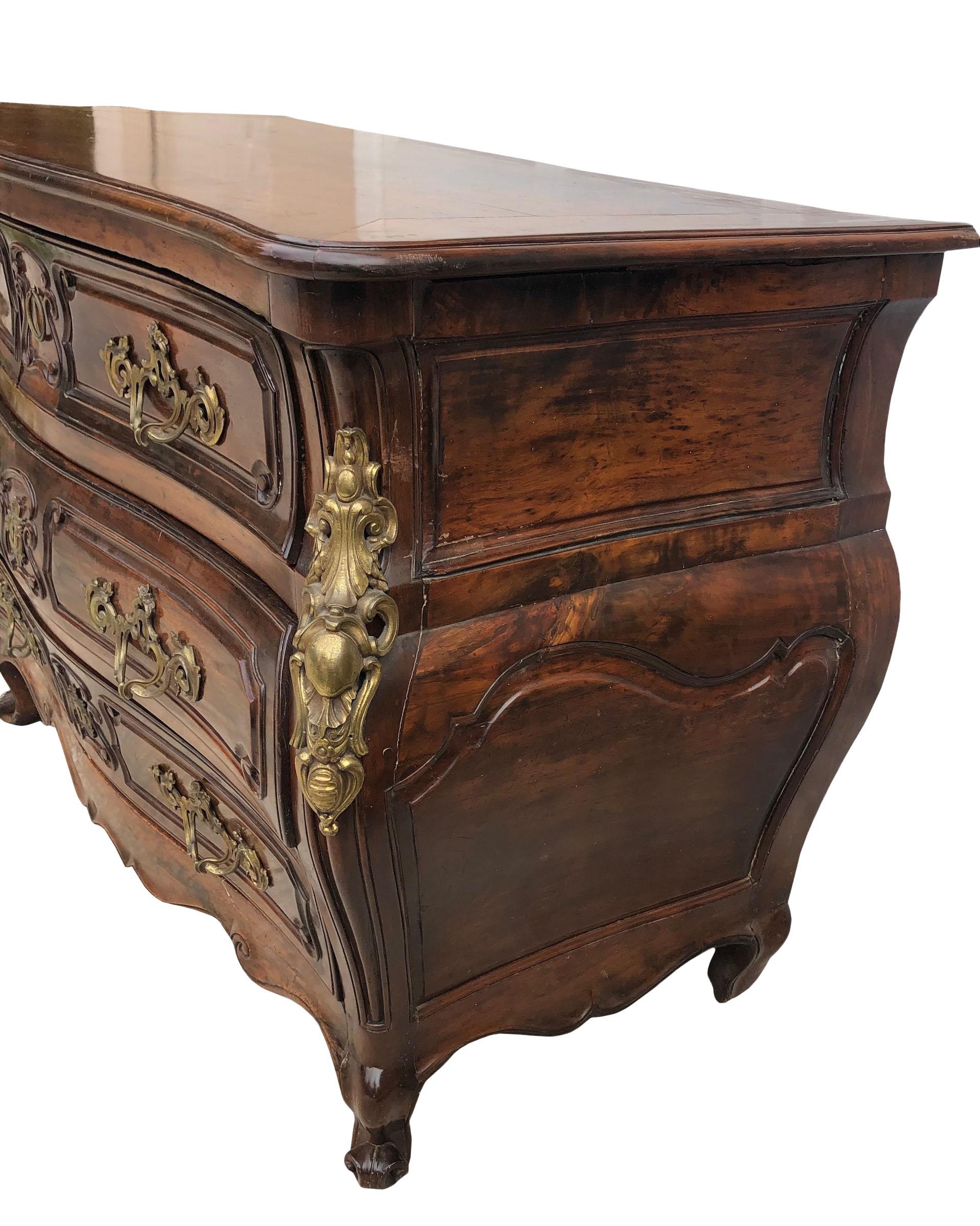 A beautiful commode from France Circa 1740s with bronze fittings. Commode has five drawers including a hidden drawer in the middle on top. The drawers are beautifully lined and trimmed in beige silk blend fabric except the hidden drawer. Original