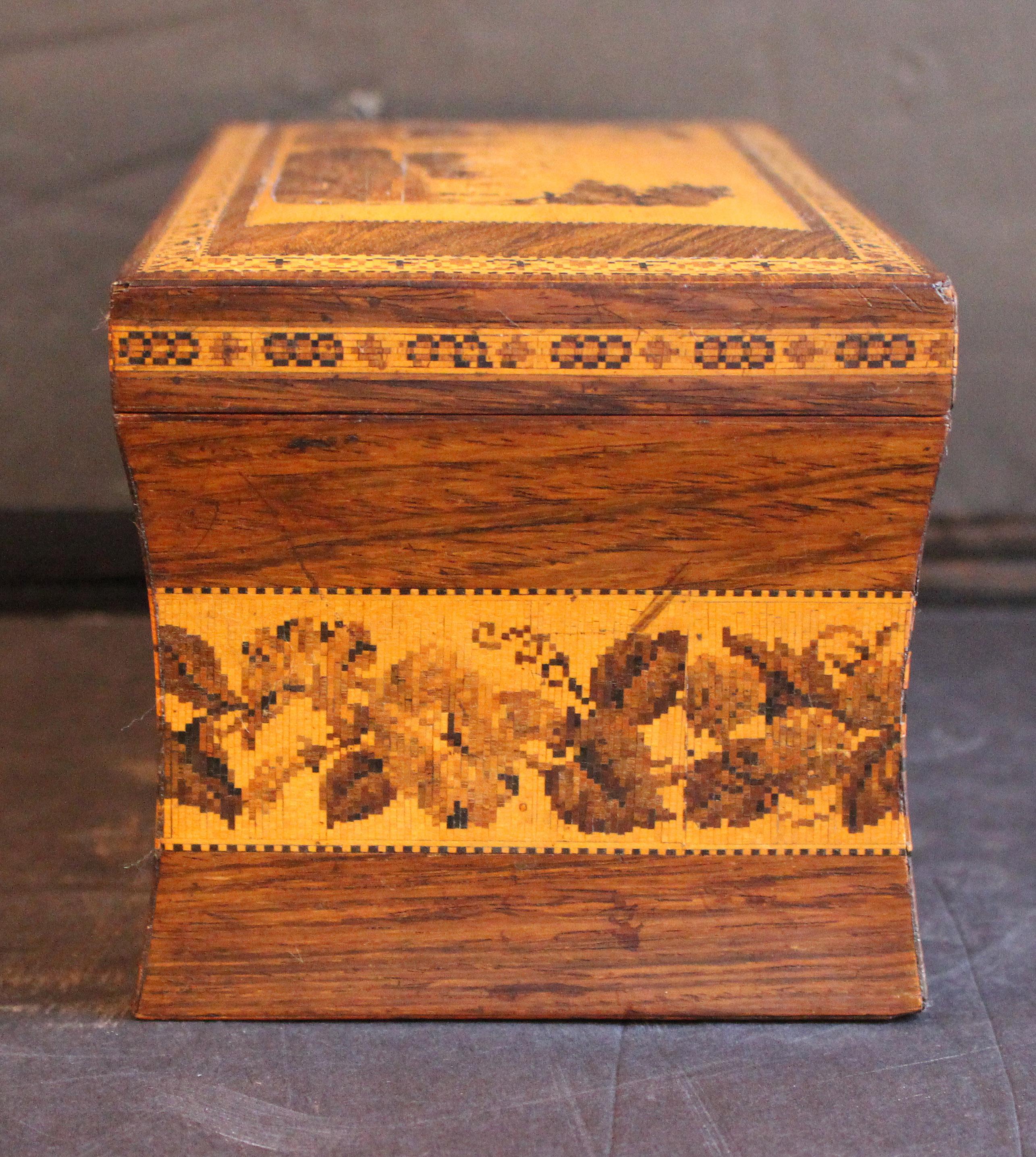 Circa 1850-60 Tunbridge Ware Tea Caddy Box, English. Featuring Eridge Castle on the lid. Two interior lidded wells for tea. Old label on bottom: Eridge Castle, Sussex. Micro mosaic bands including a wide floral band on the concave body. Note even