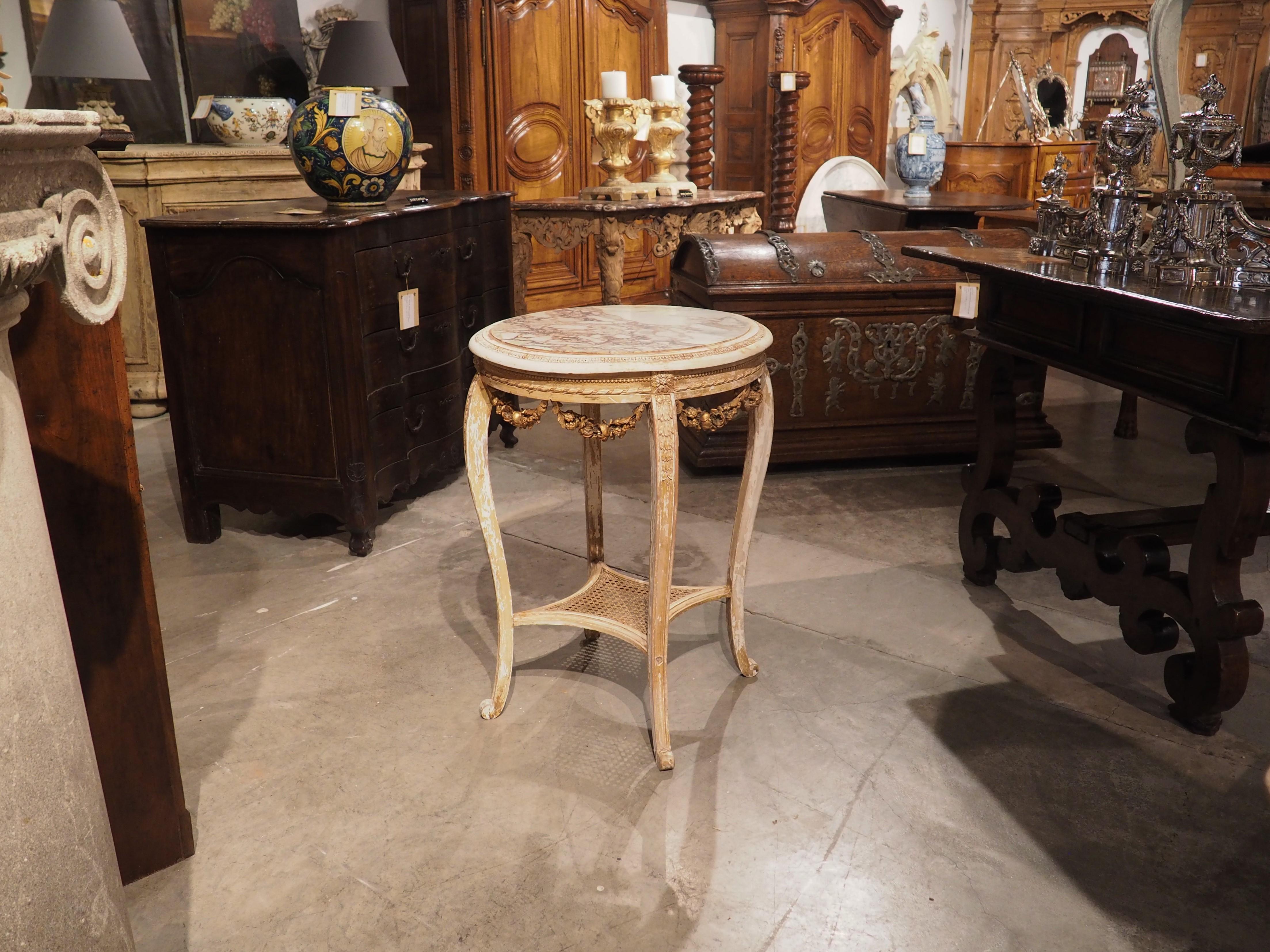 Hand carved in France, circa 1850, this parcel gilt side table with breche marble top is from the Napoleon III period. Sometimes referred to as “Second Empire style”, a hallmark of the period, which incorporates motifs from numerous periods, is to
