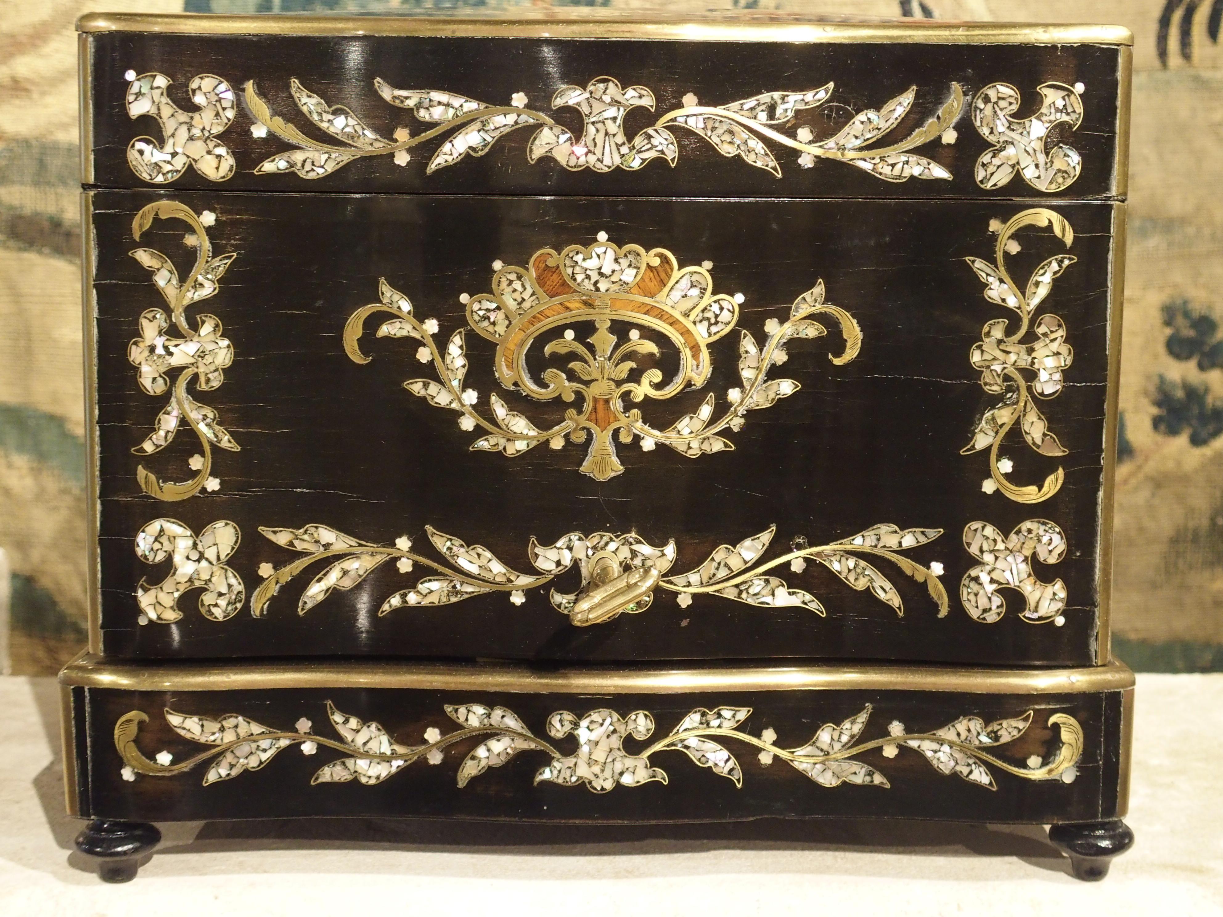 This detailed French cave à liqueur is from the middle of the 19th century. These boxes became popular around this time, and some beautiful examples were made for the growing bourgeoisie class of France. The boxes were fitted with locks and keys to