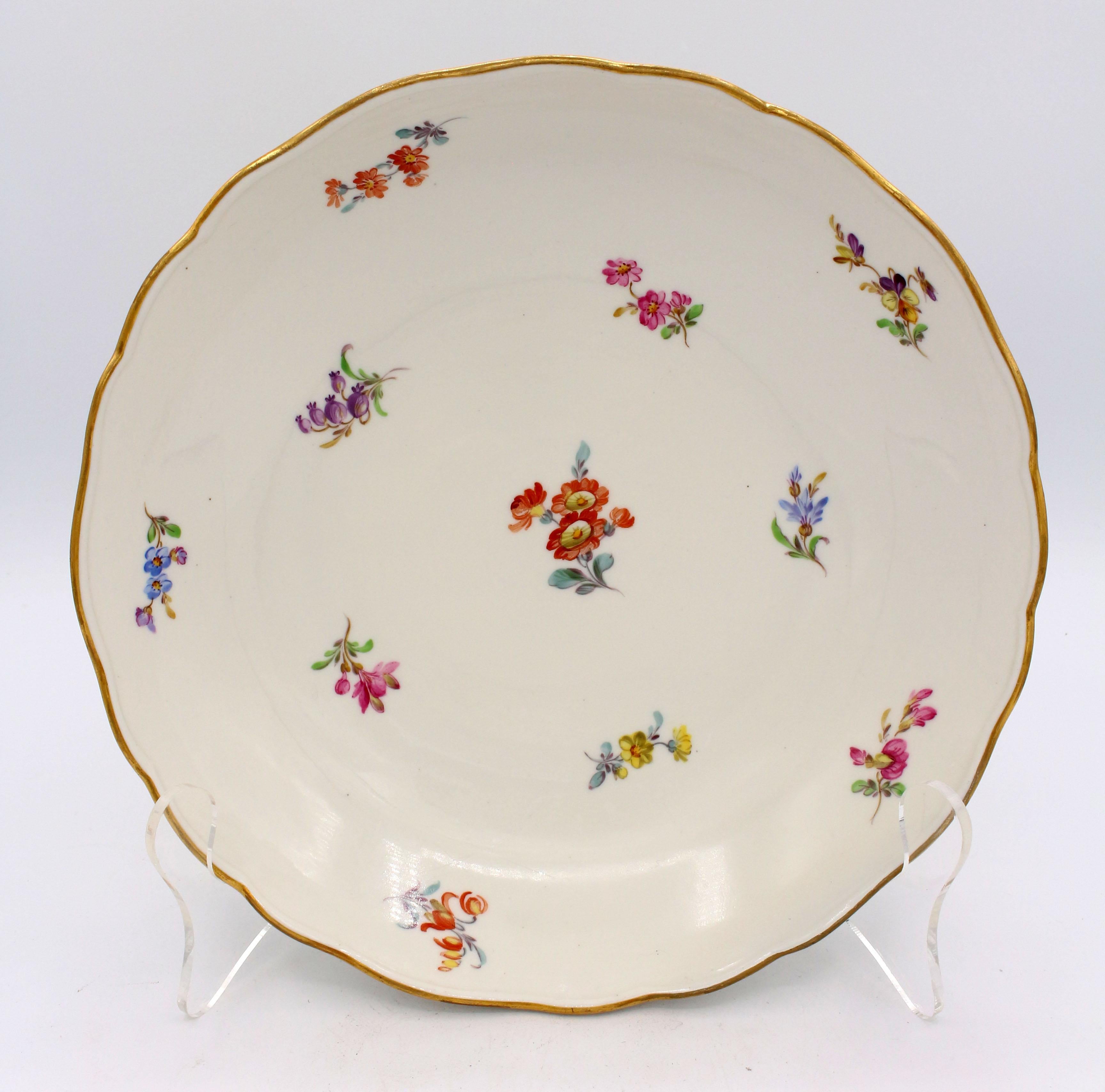 Fruit bowl or low serving bowl with gilt scalloped edge (minor wear), by Meissen in the scattered flowers or streublumen pattern. Crossed swords mark. c.1860-90. Apparent pre-glaze repair.
9 5/8