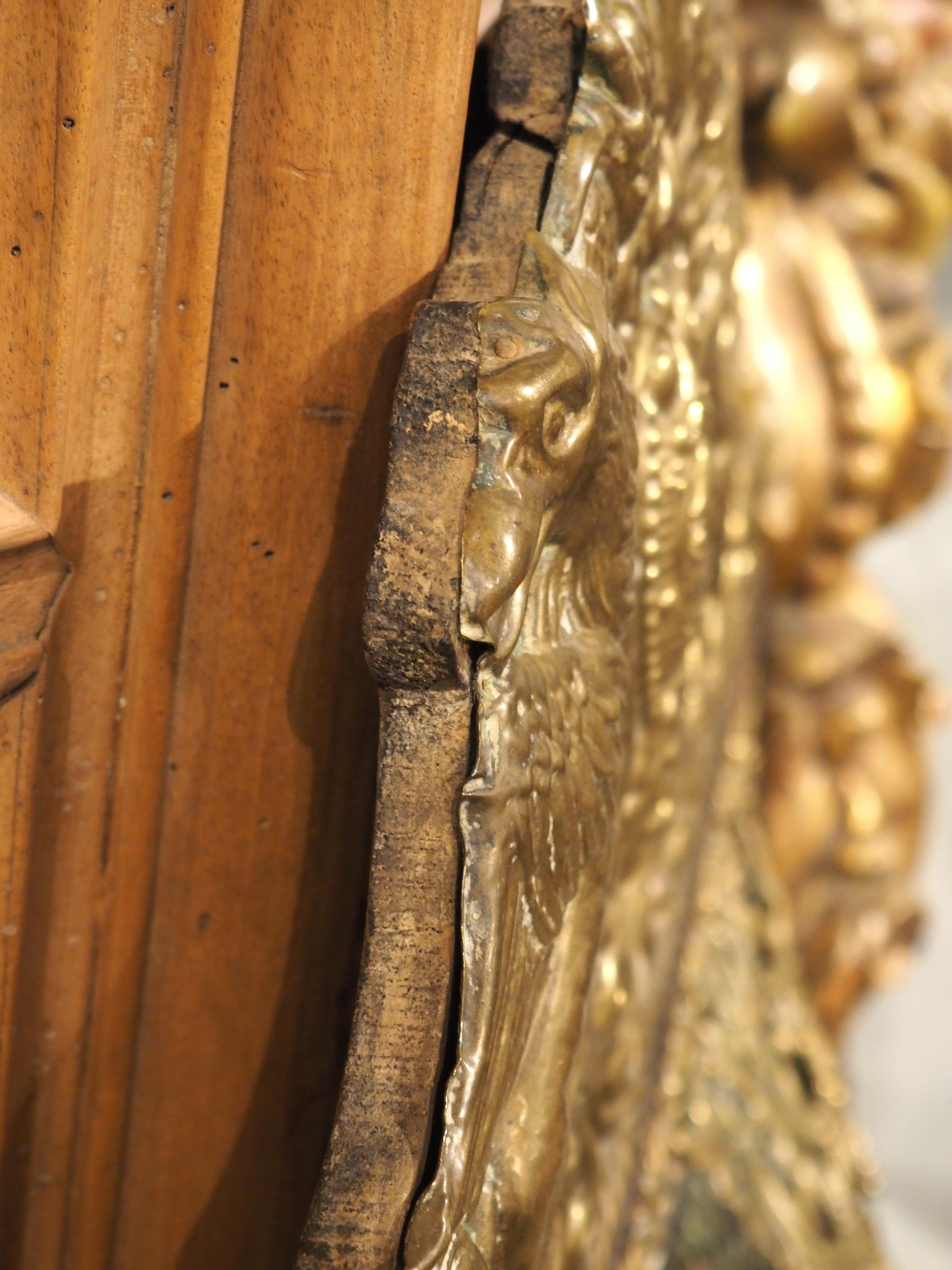 More information coming soon…

This Dutch parclose mirror is topped by an elaborate coat of arms crest in the style of Louis XIV.  Dating to circa 1860, the center and side mirrors are separated by an equally impressive floral and foliate display,